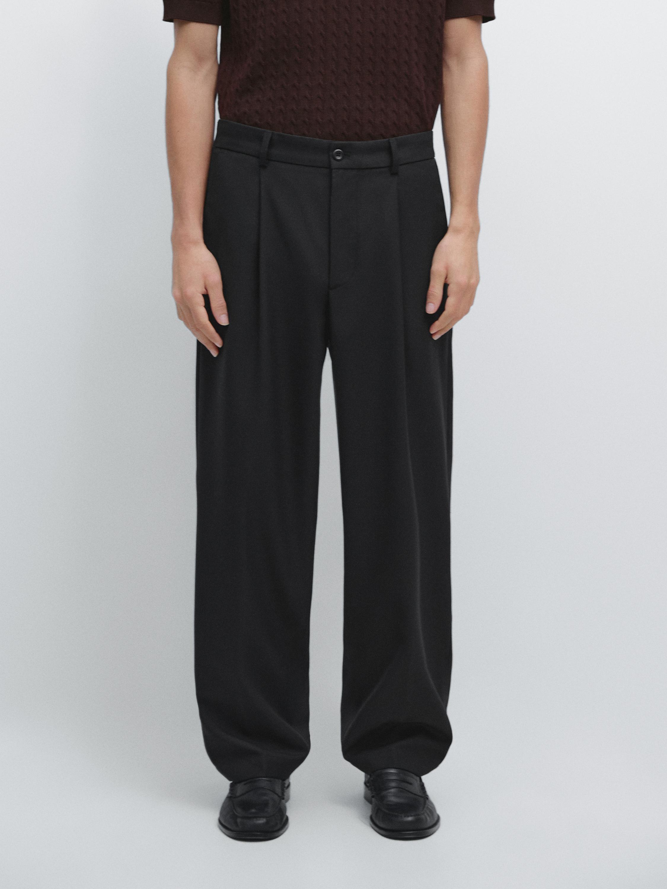 Black relaxed fit pants set with pleats and side pockets.
