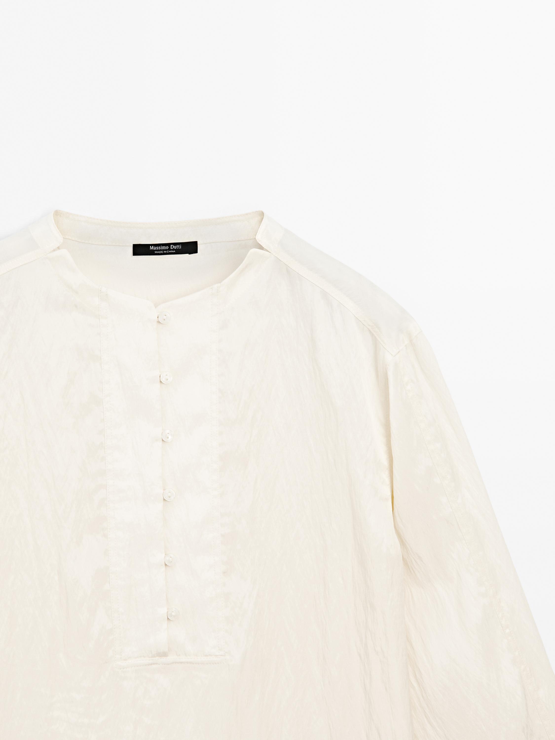 Flowing shirt with button detail on the chest · Cream