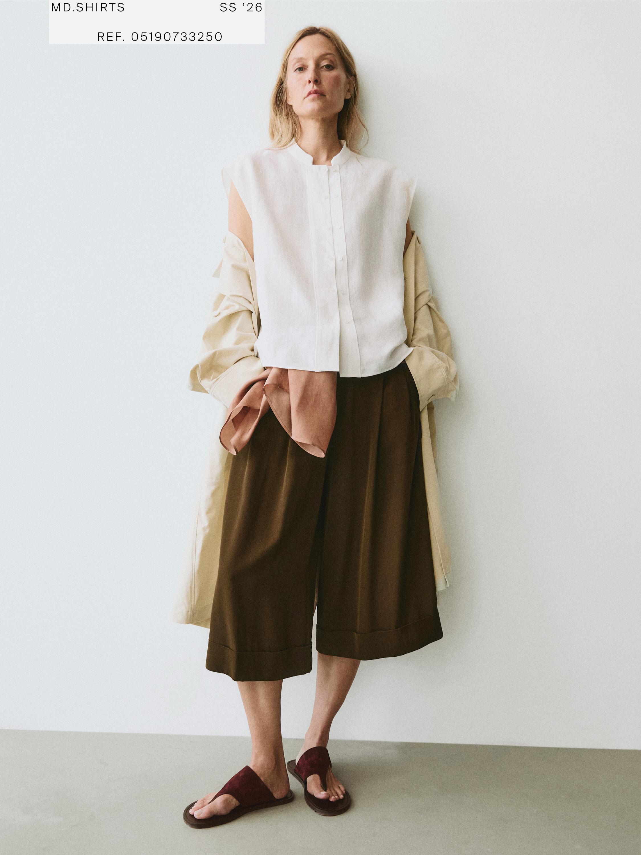White sleeveless button-down shirt, brown culottes, and burgundy sandals set.