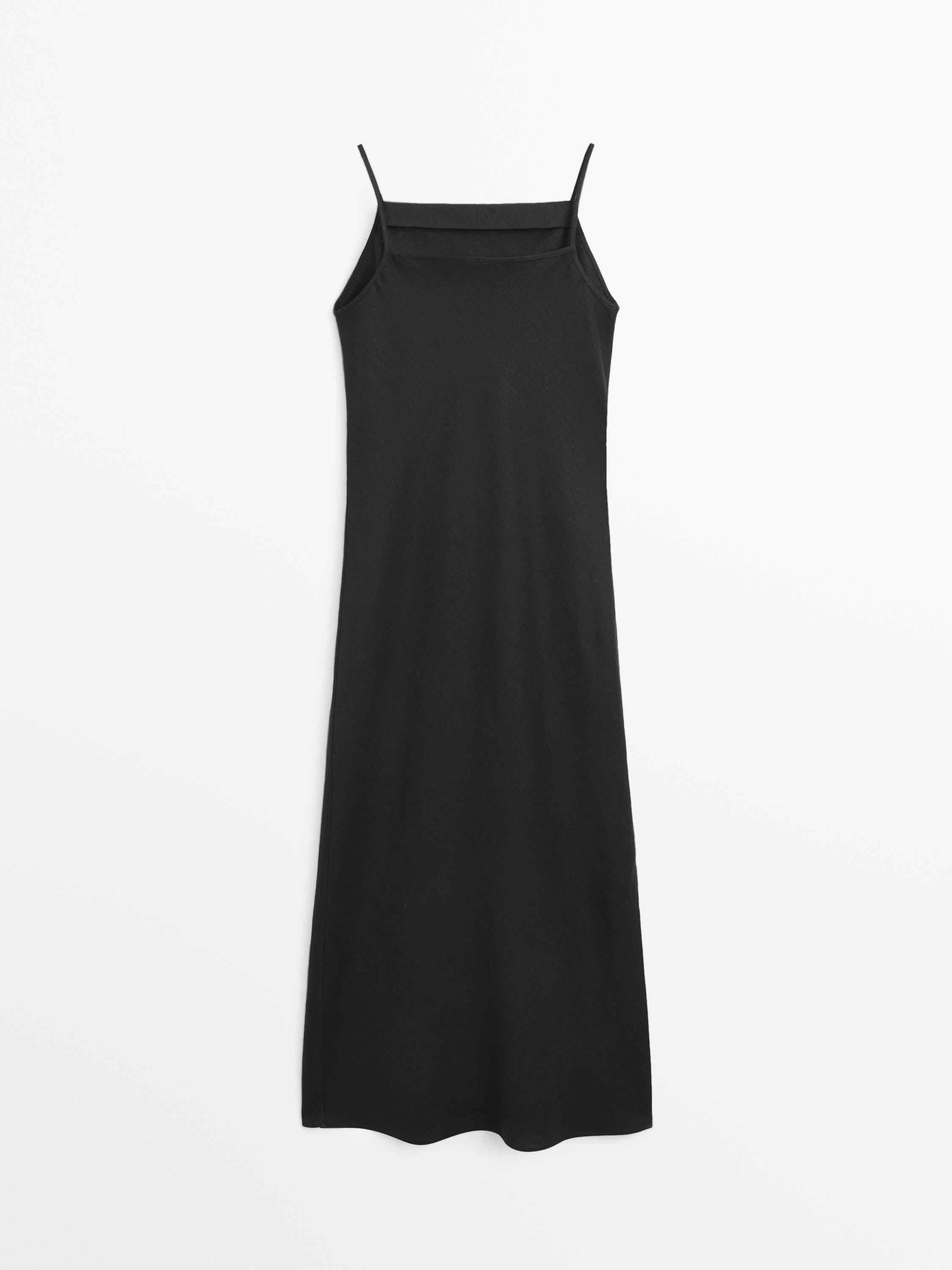 Widok z przodu krótkiej czarnej sukienki z cienkimi ramiączkami i prostym dekoltem.