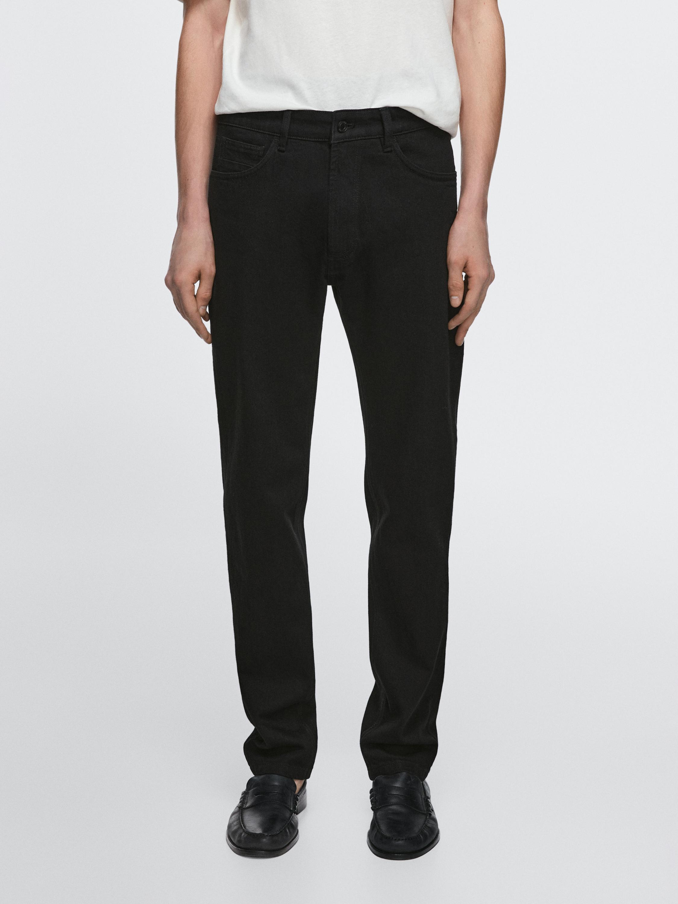 Black slim-fit jeans set with visible front and back pockets.