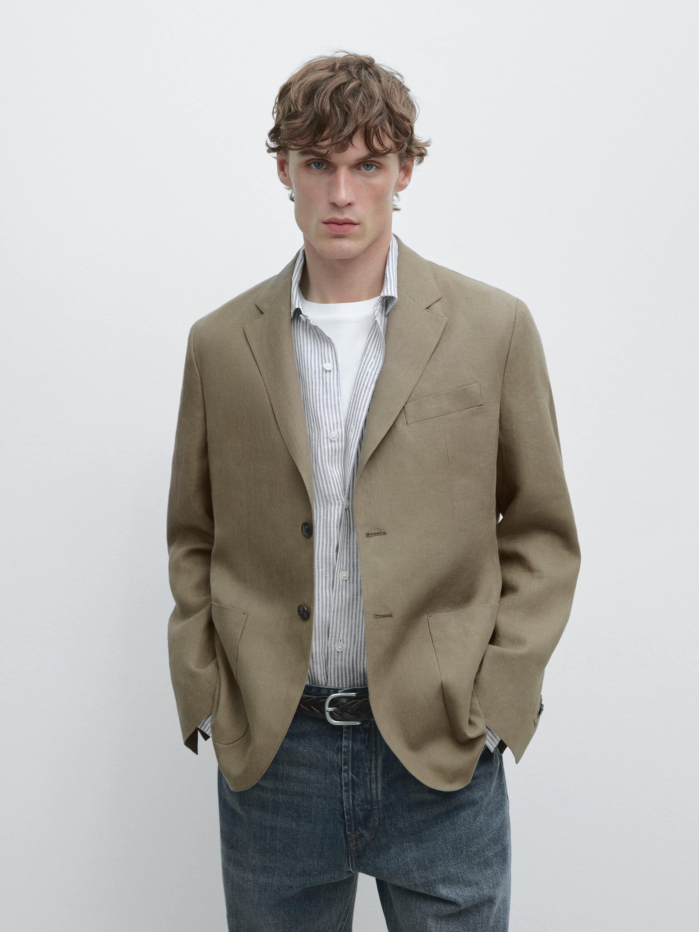 Casual greenish blazer set with side pockets, striped shirt, and blue denim pants.