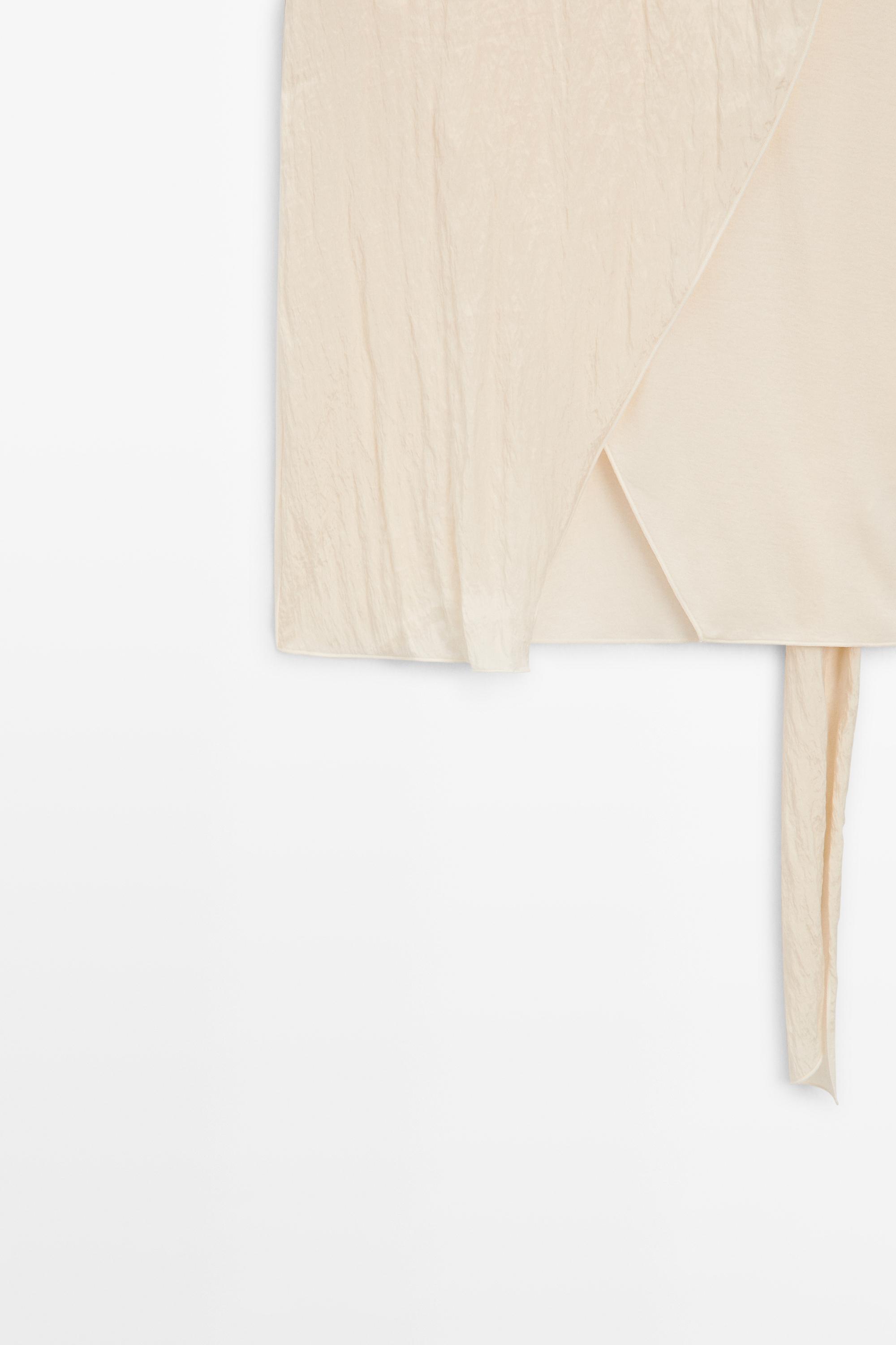 Crossover top with shoulder scarf detail — CREAM