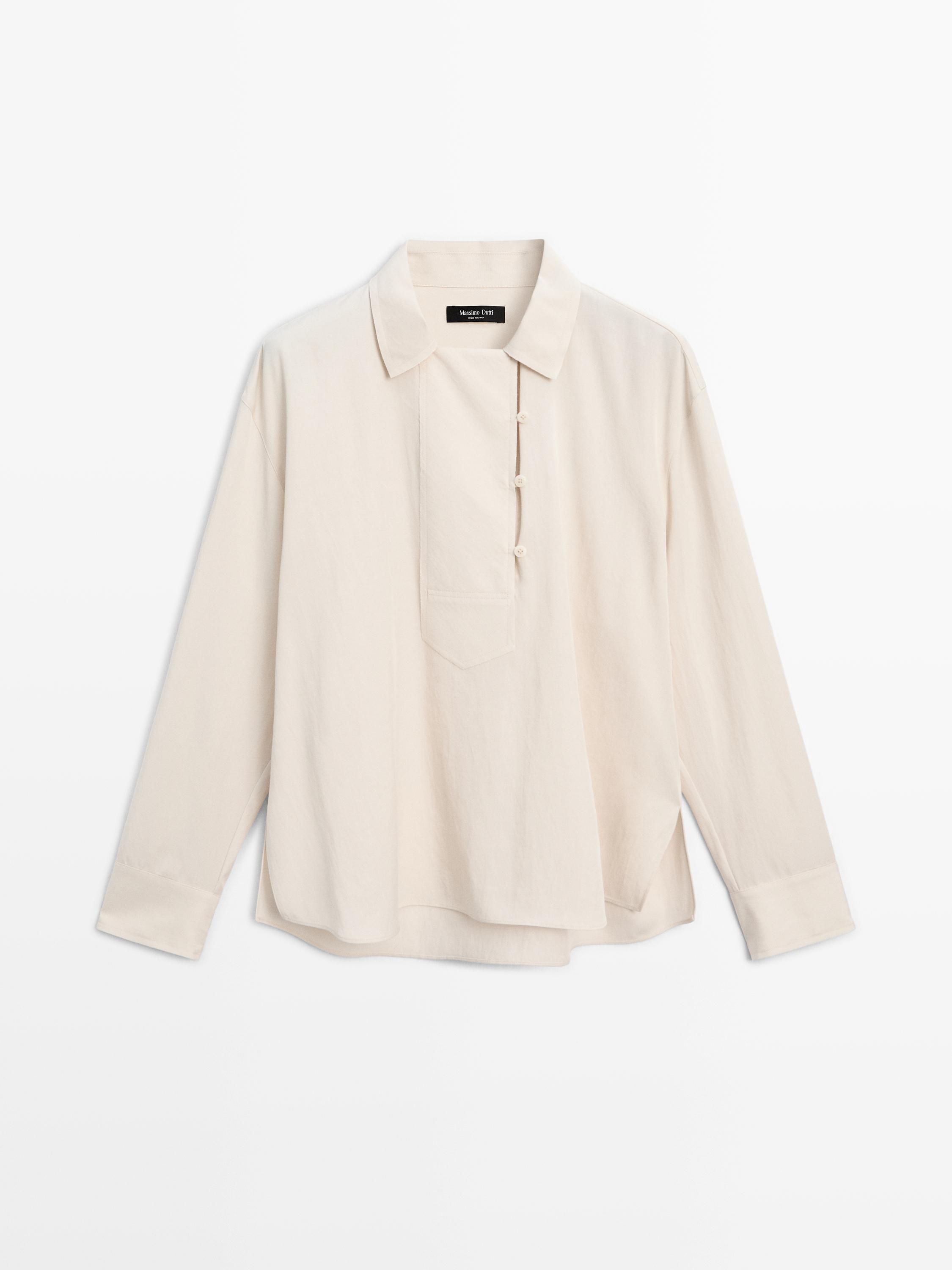 Blusa fluida com pormenor de abotoadura