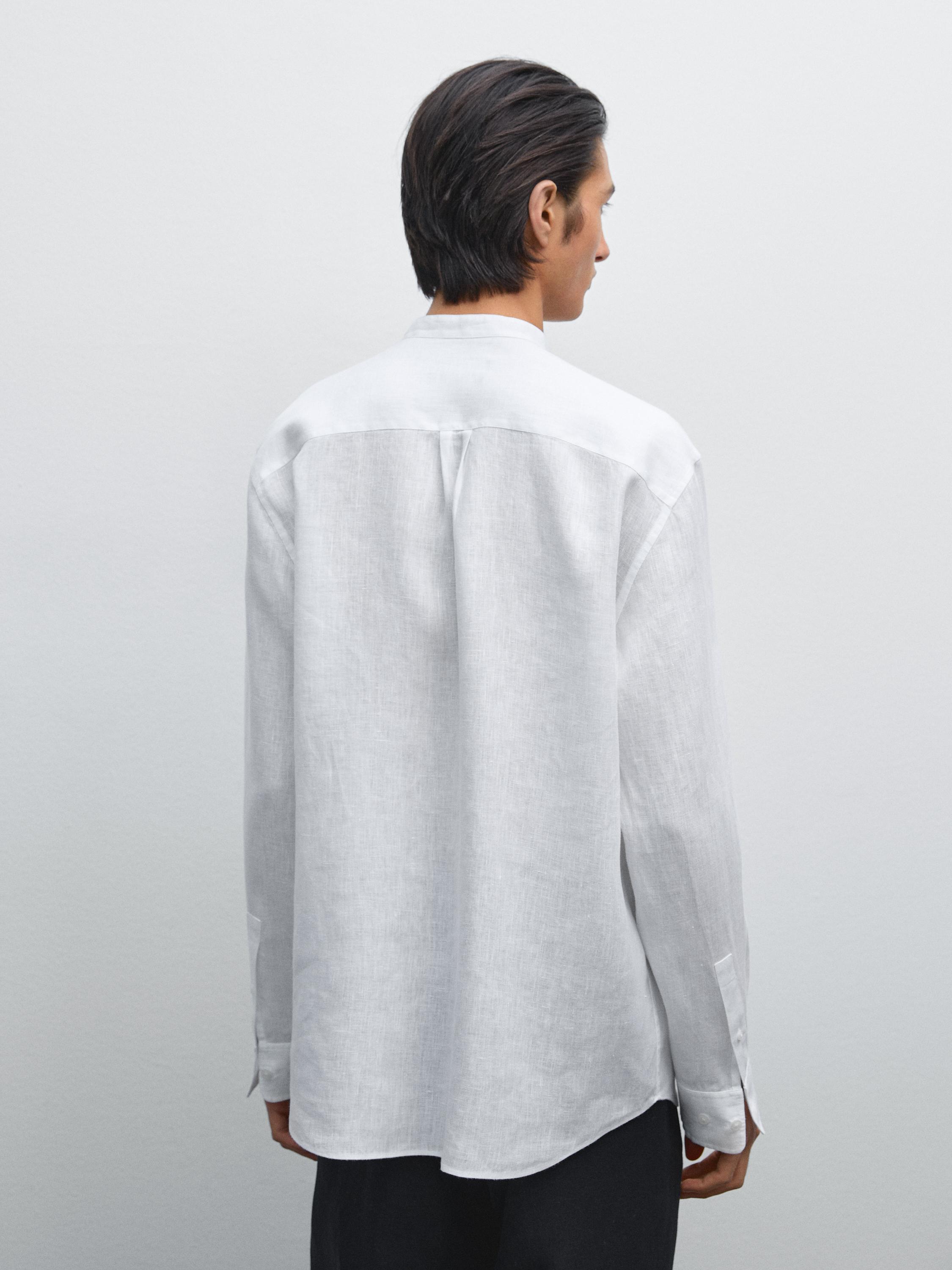 Back view of white shirt with mandarin collar and long sleeves.
