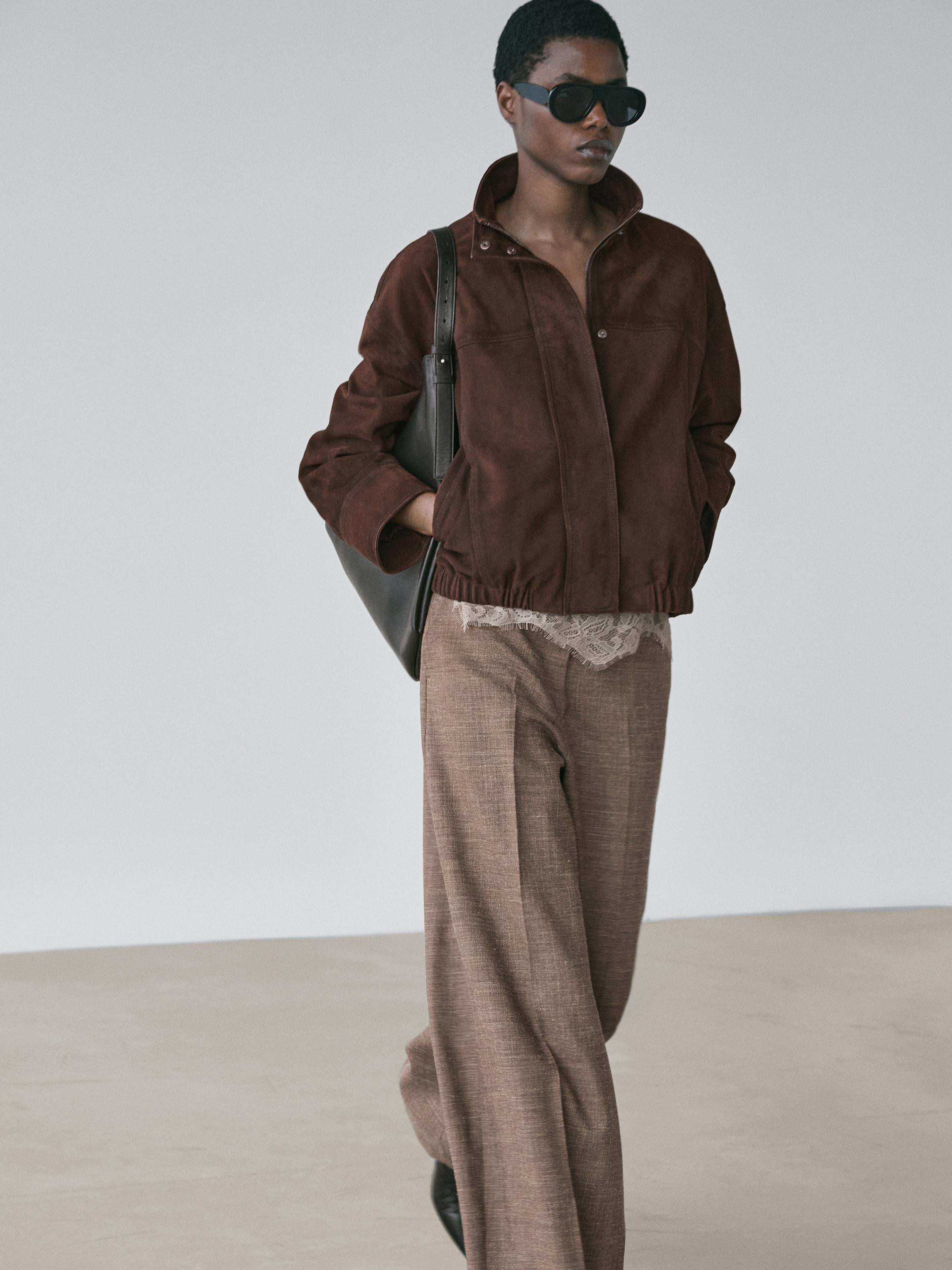 Brown zippered jacket and taupe wide-leg pants set, visible side pockets.