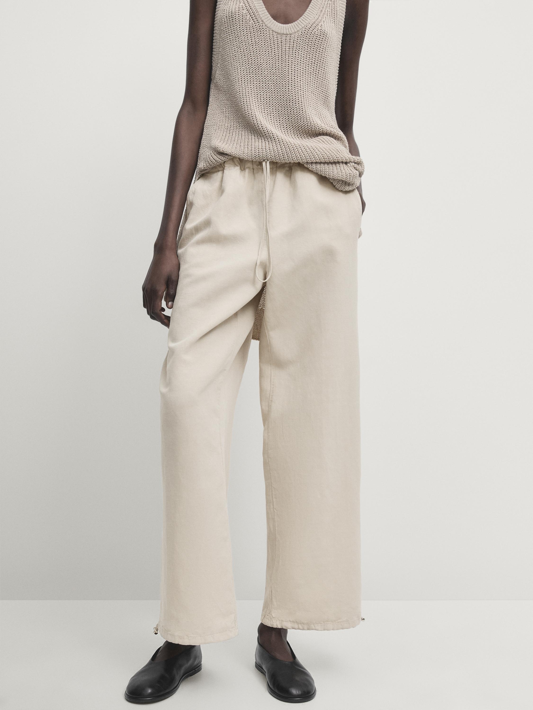 Trousers with elasticated waistband and adjustable hems