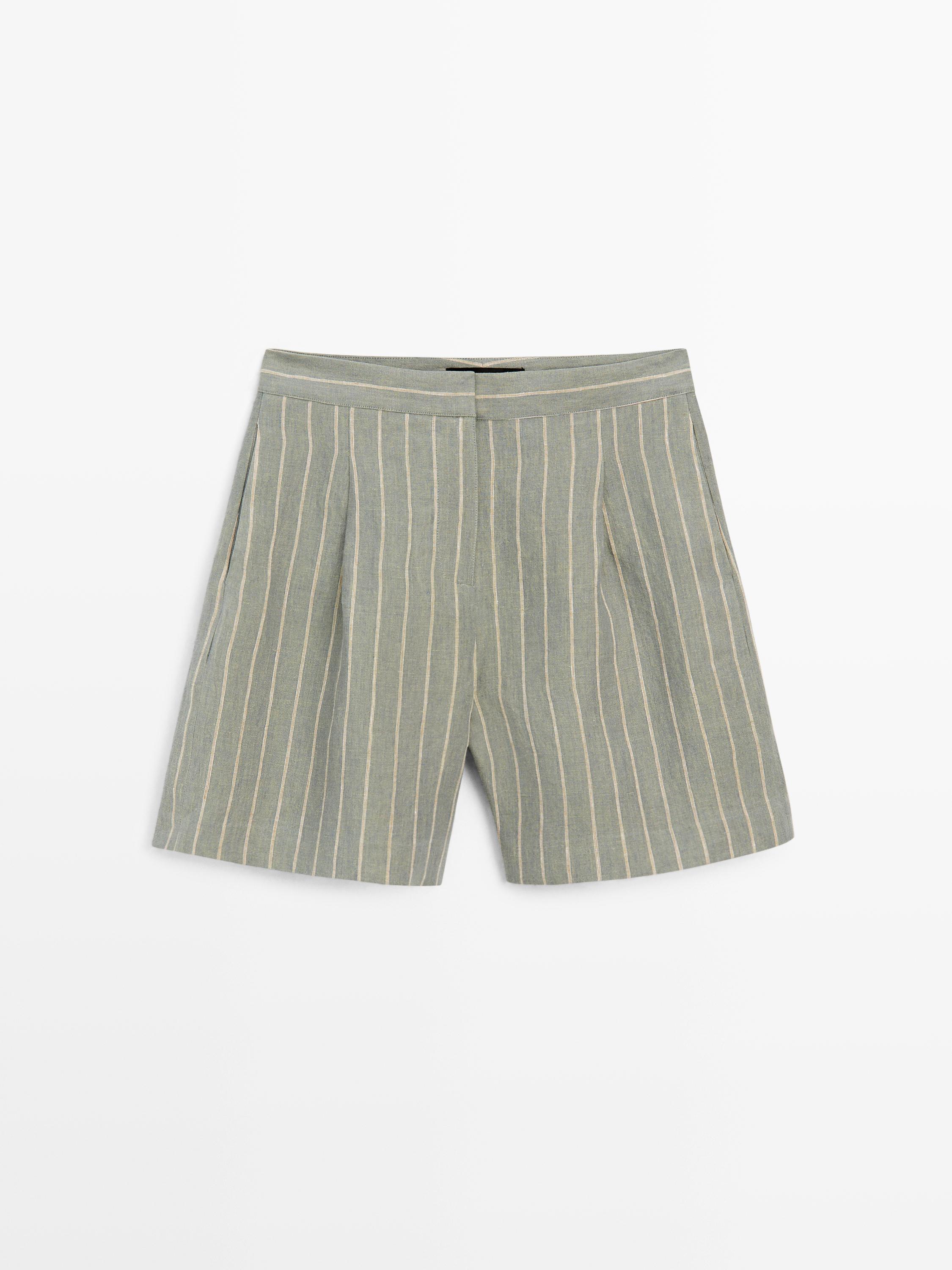 Front view of pistachio shorts with vertical stripes and side pockets.