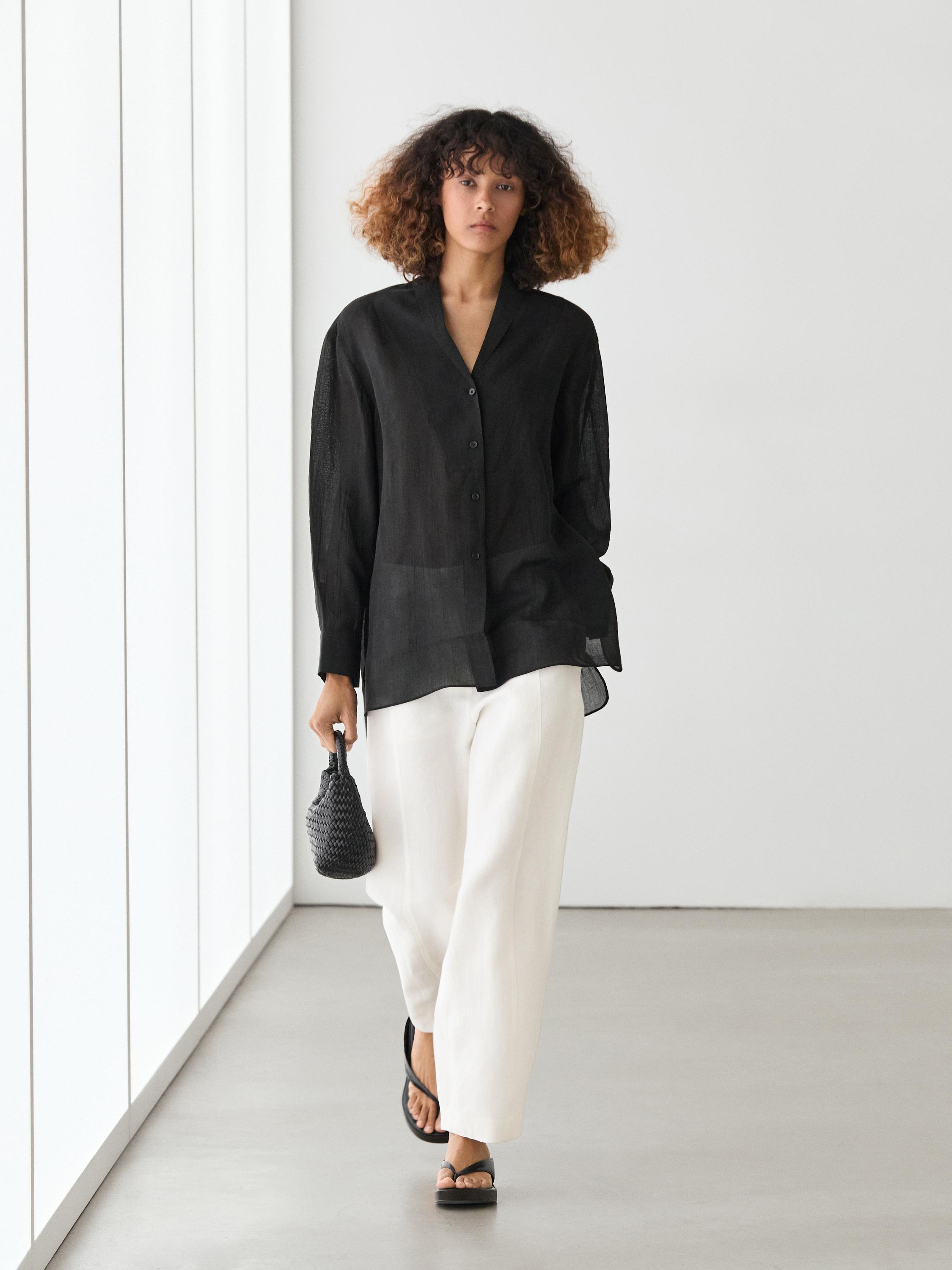 Flowing semi-sheer shirt with chest detail — BLACK