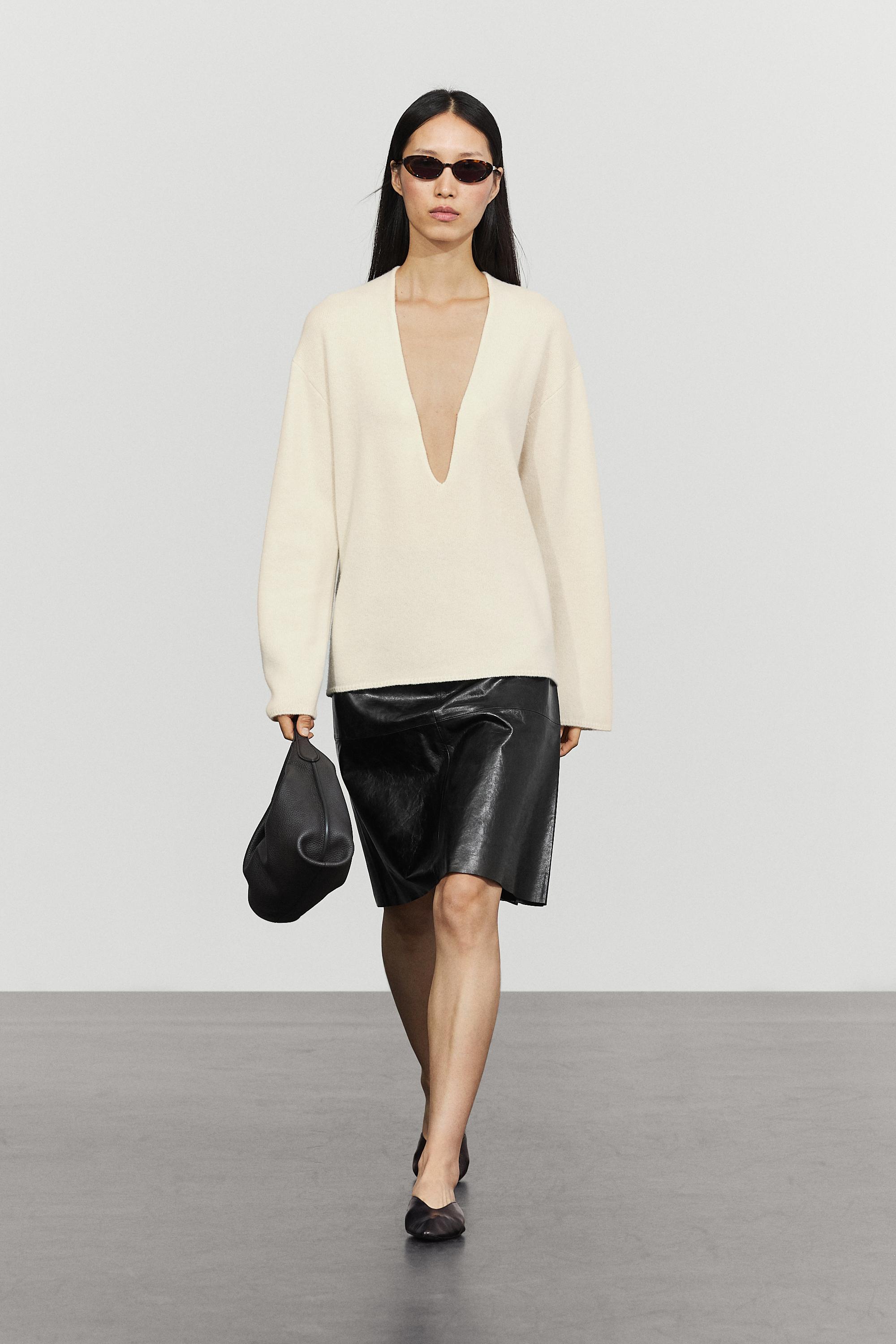 Long-line knit sweater with neckline detail