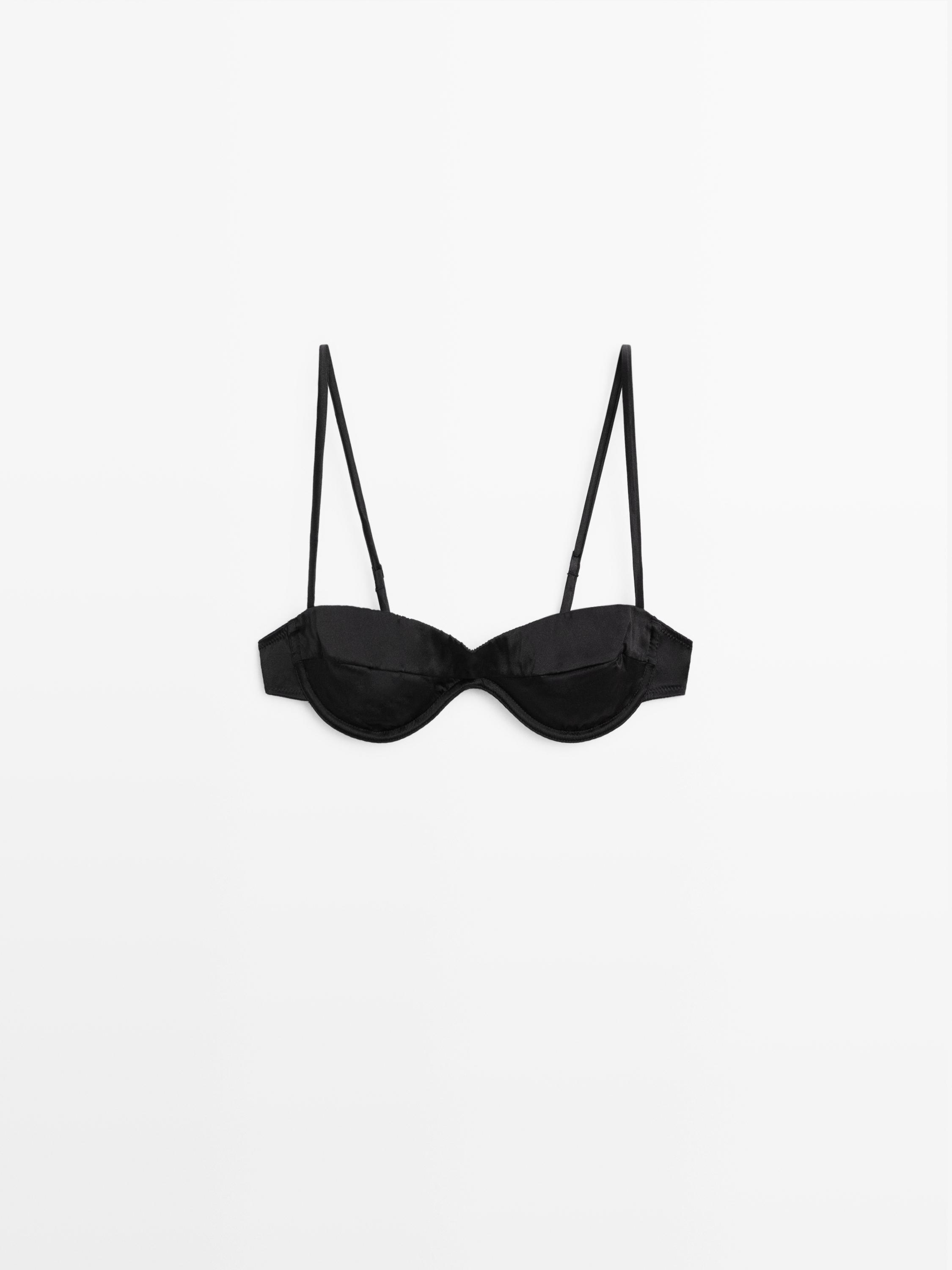 Vorderansicht eines schwarzen Bandeau-BHs mit Bügeln und Falten-Detail, dünne, verstellbare Träger.