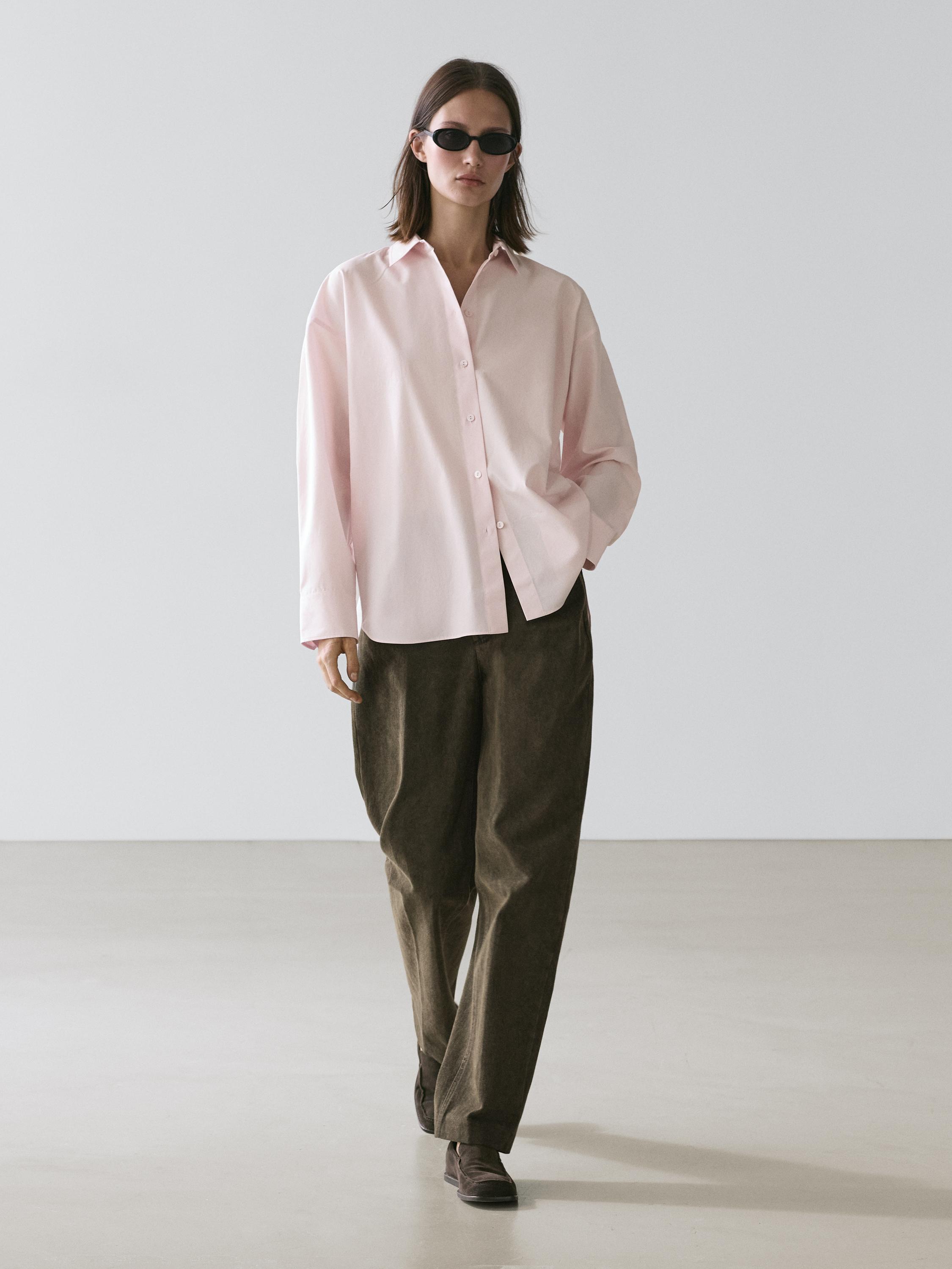 Pink button-down shirt and wide brown pants set.
