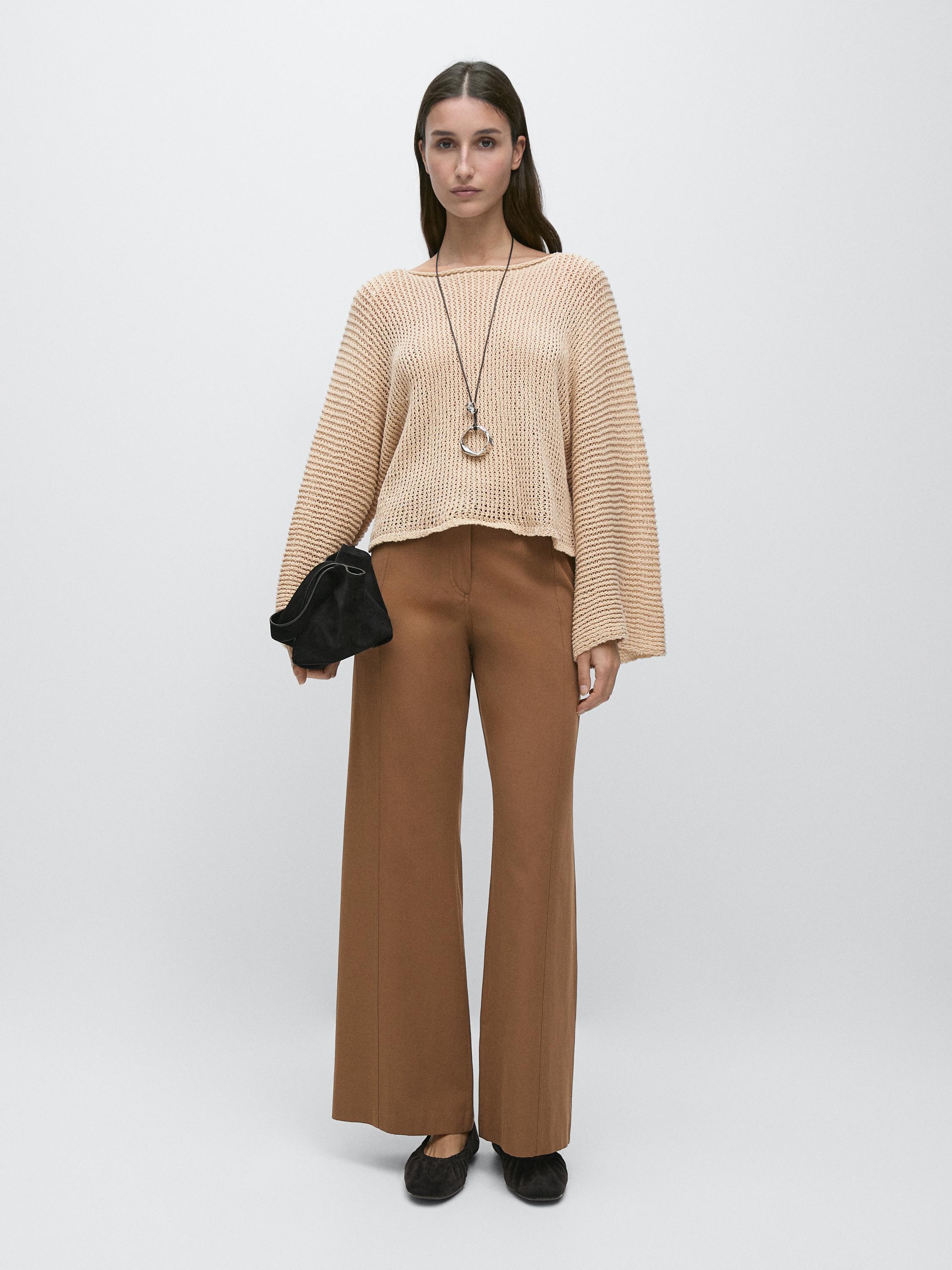 Tobacco flare pants set and beige knit sweater with wide sleeves.