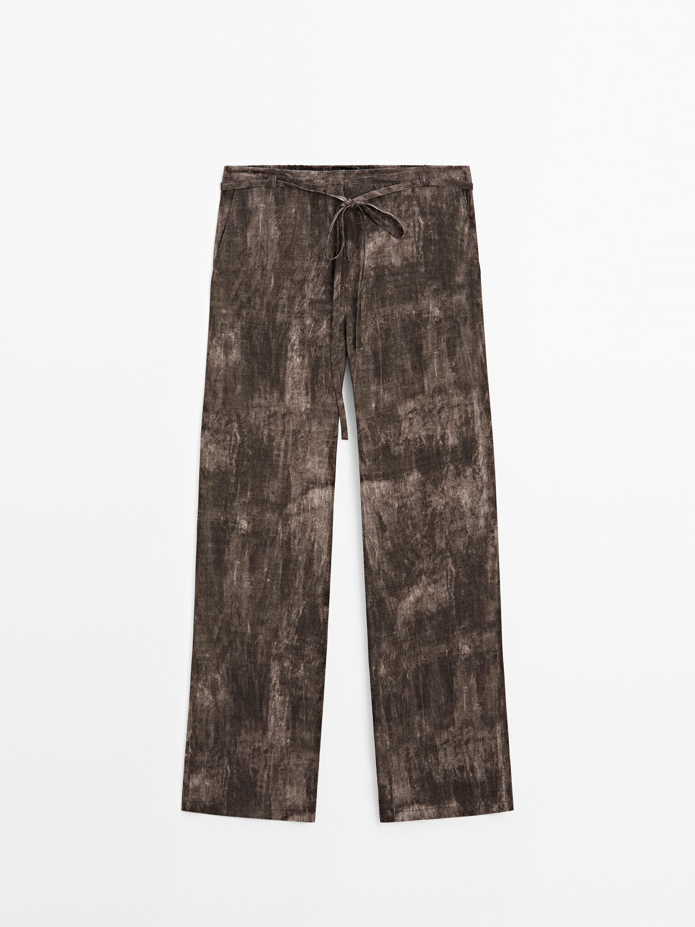 Distressed-effect flared trousers