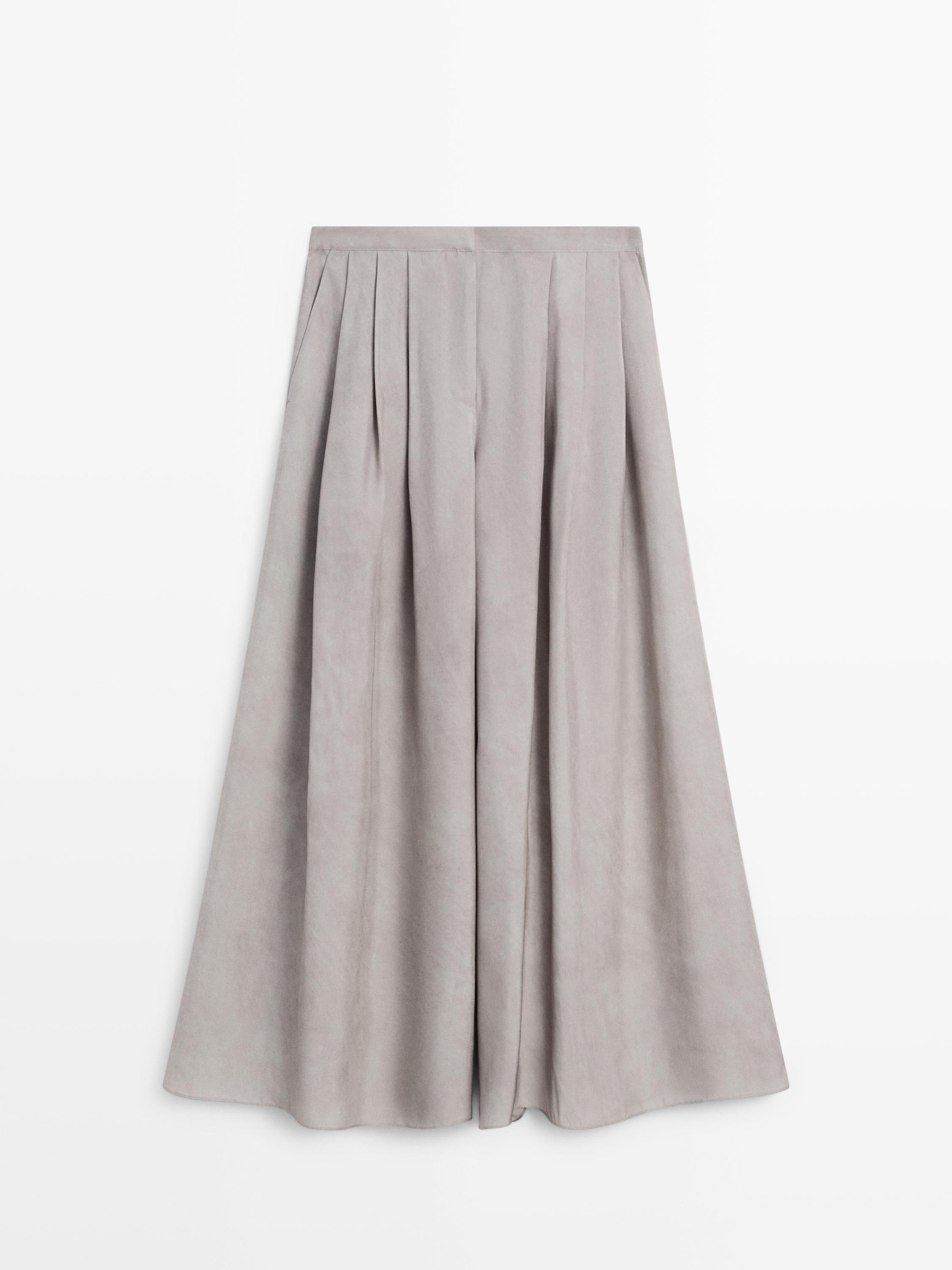 Front view of gray pants with wide pleats and a high waist.