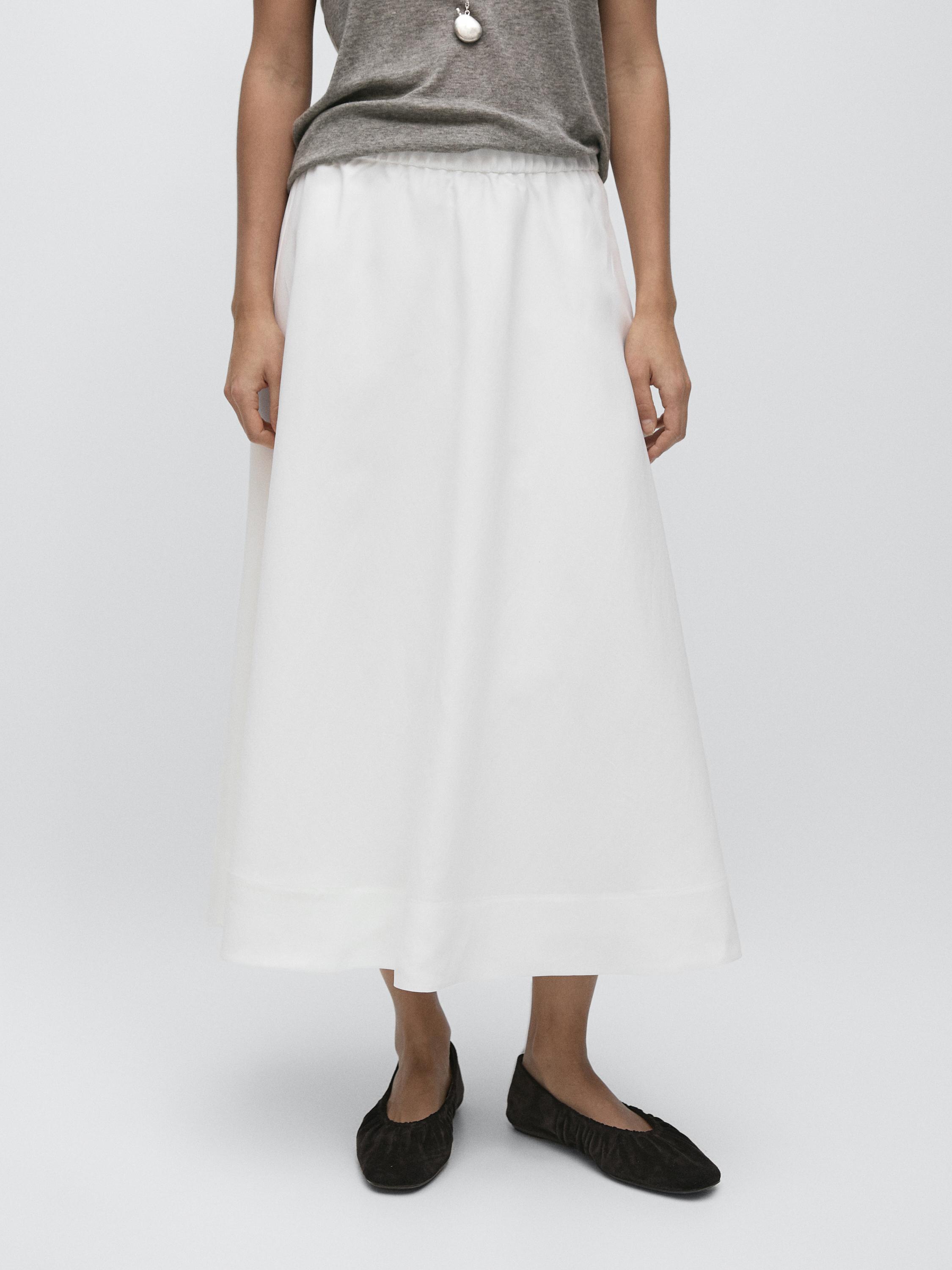 Flowy white midi skirt set with elastic waist and gray t-shirt.
