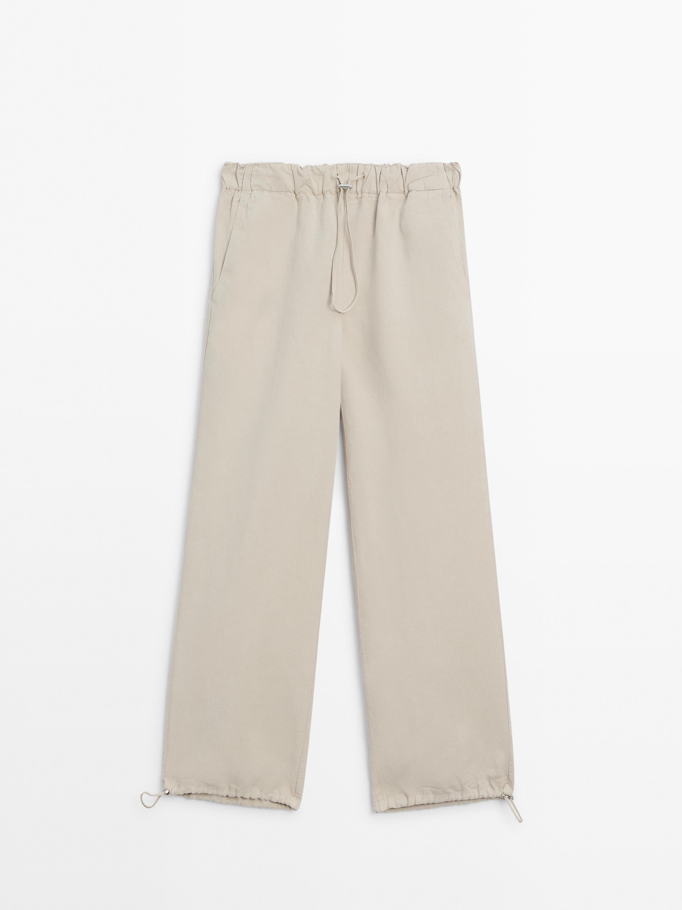 Trousers with elasticated waistband and adjustable hems
