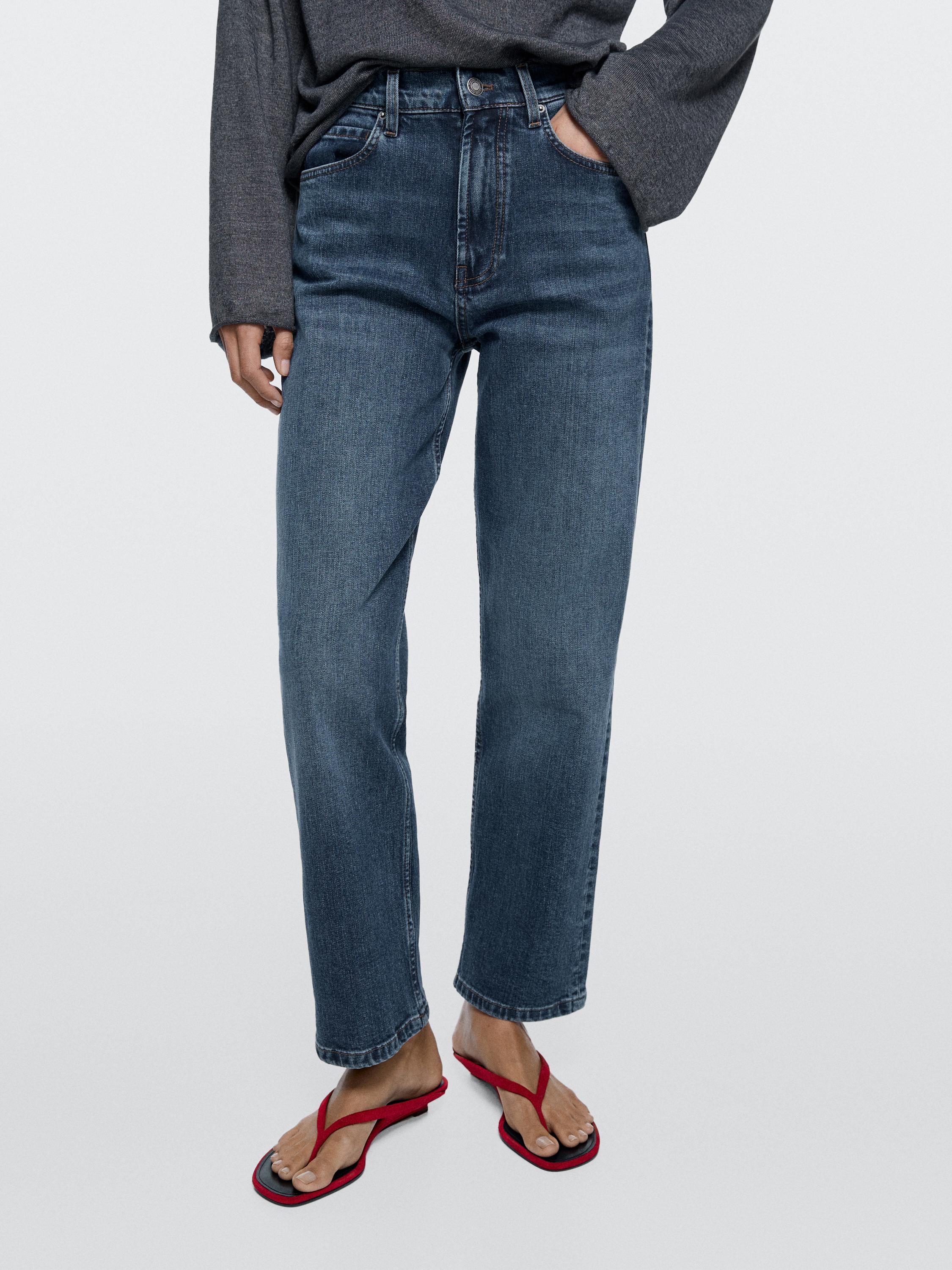 Medium shot of medium blue straight fit jeans with a mid-rise, visible front and back pockets.