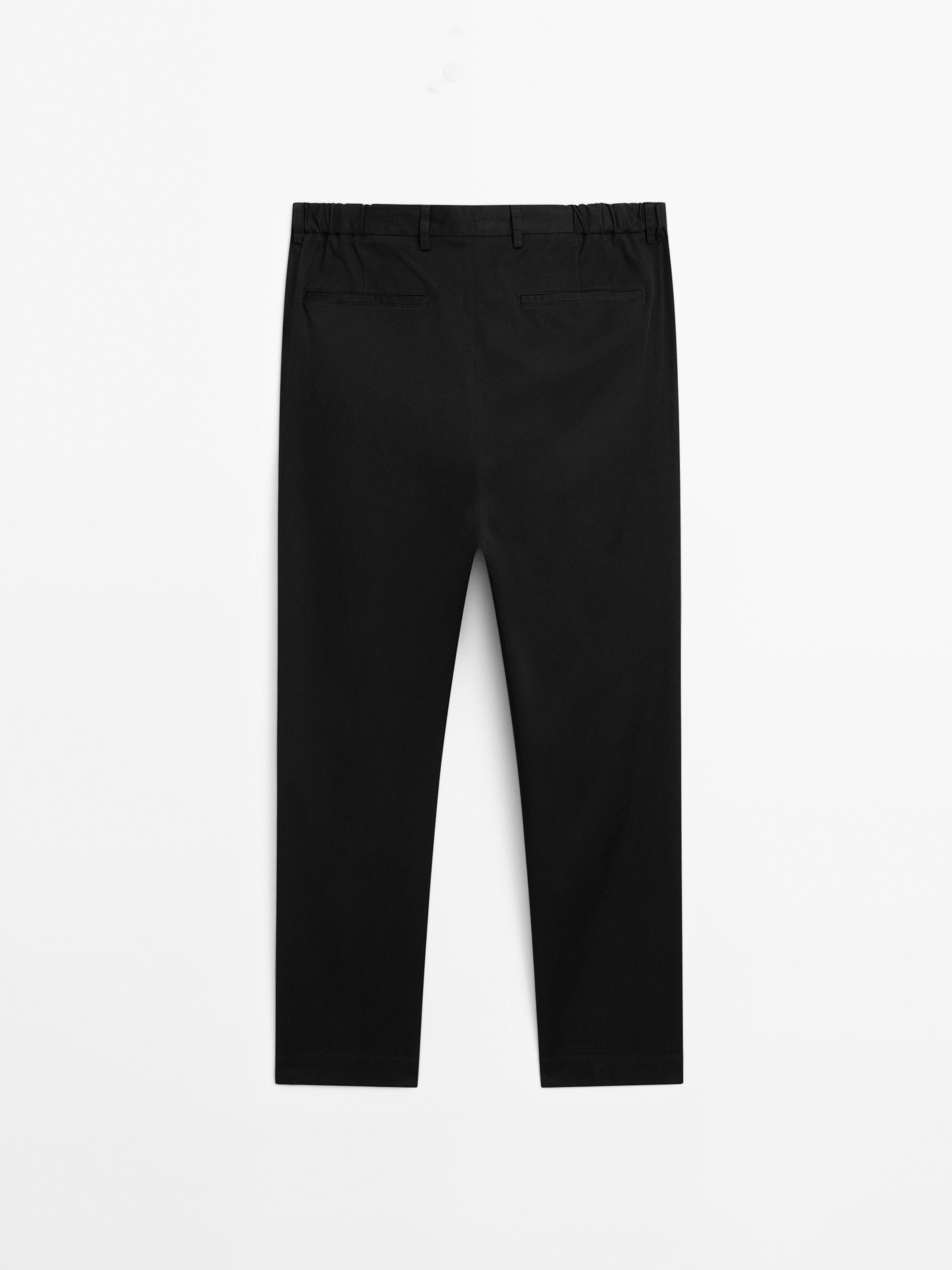 Tapered fit trousers with side elastic detail