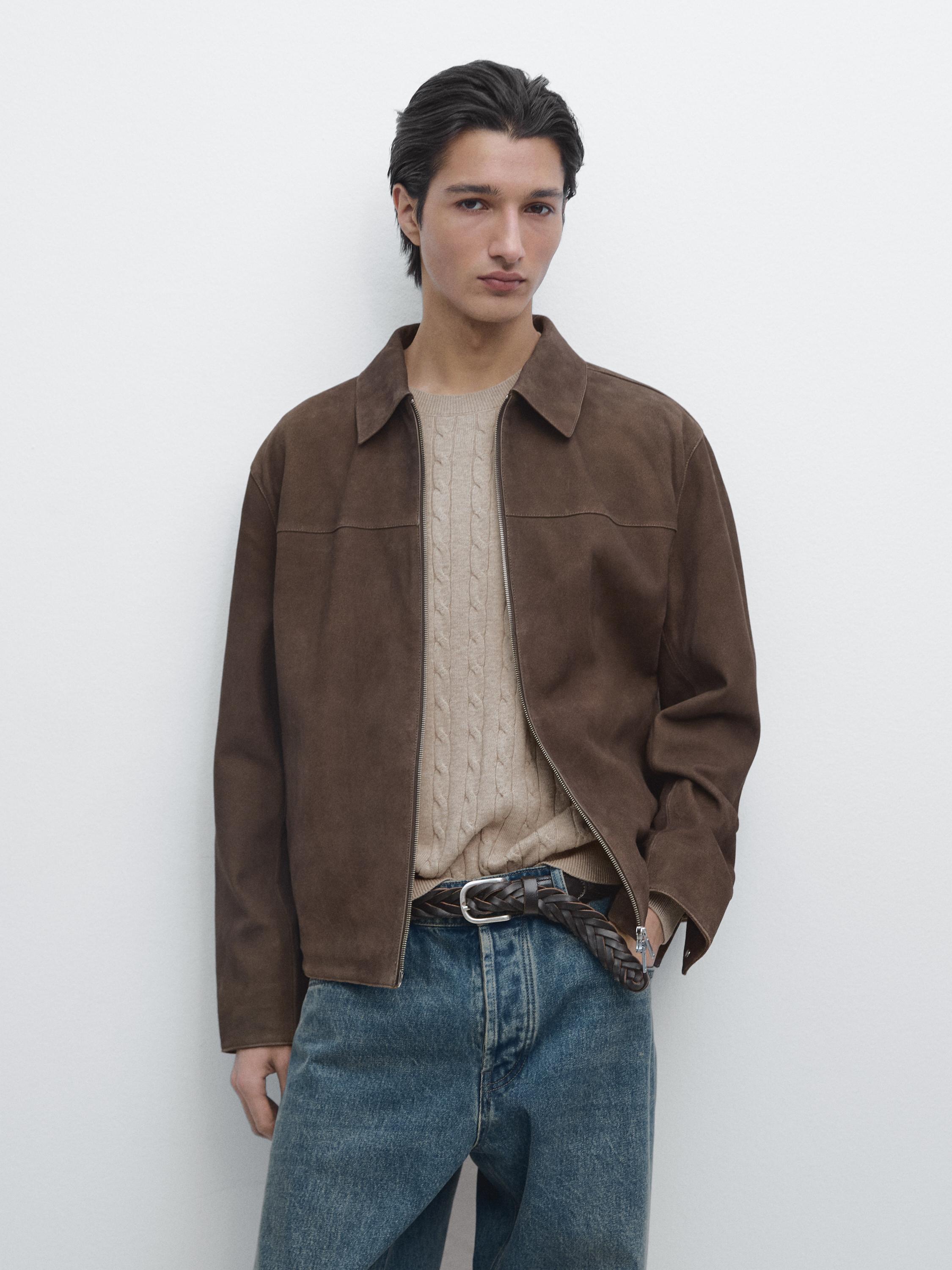 Taupe brown jacket set with zipper and classic collar, beige cable knit sweater, and blue jeans.