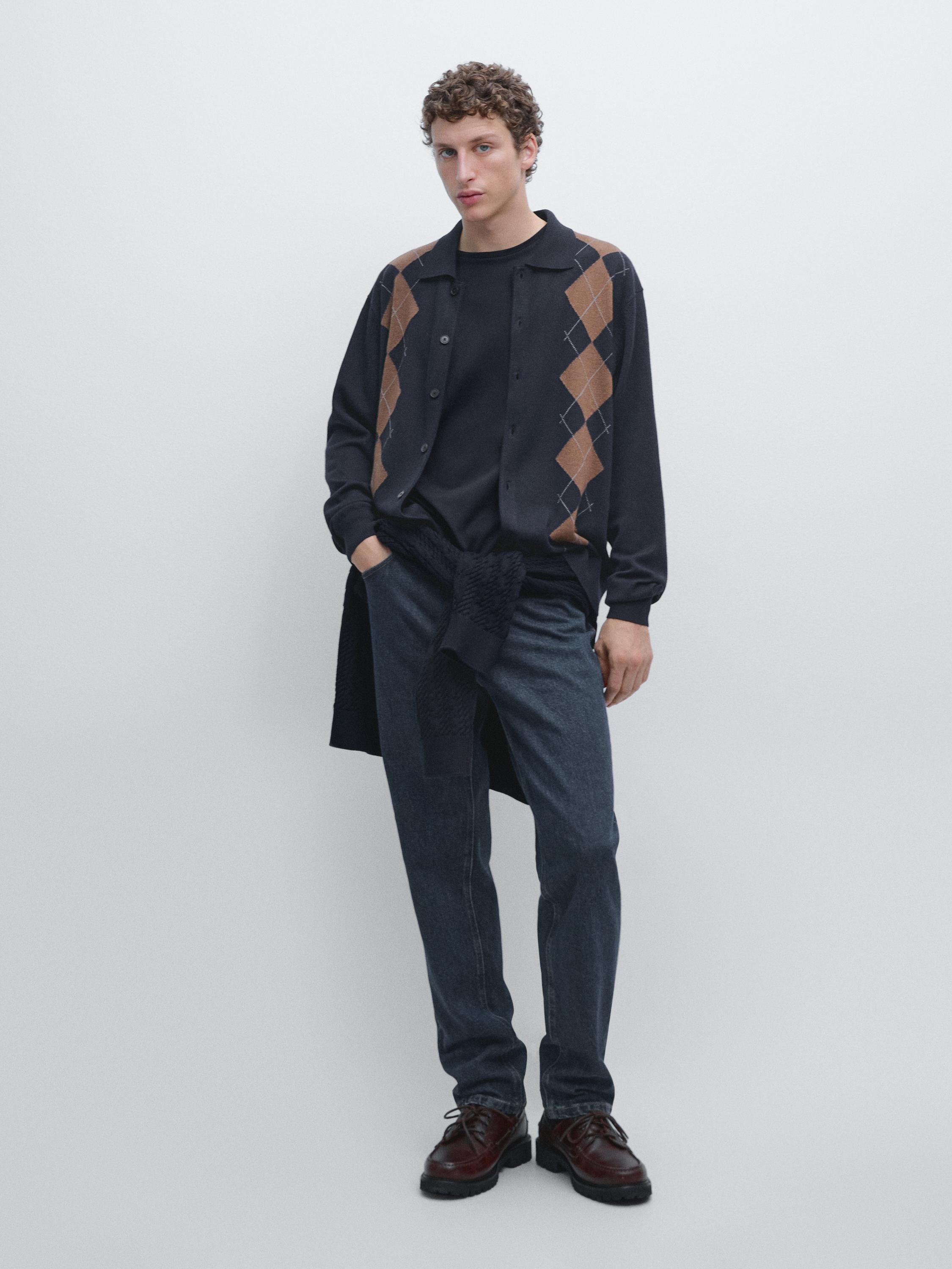 Navy blue argyle cardigan set, black t-shirt, dark jeans, and brown shoes.