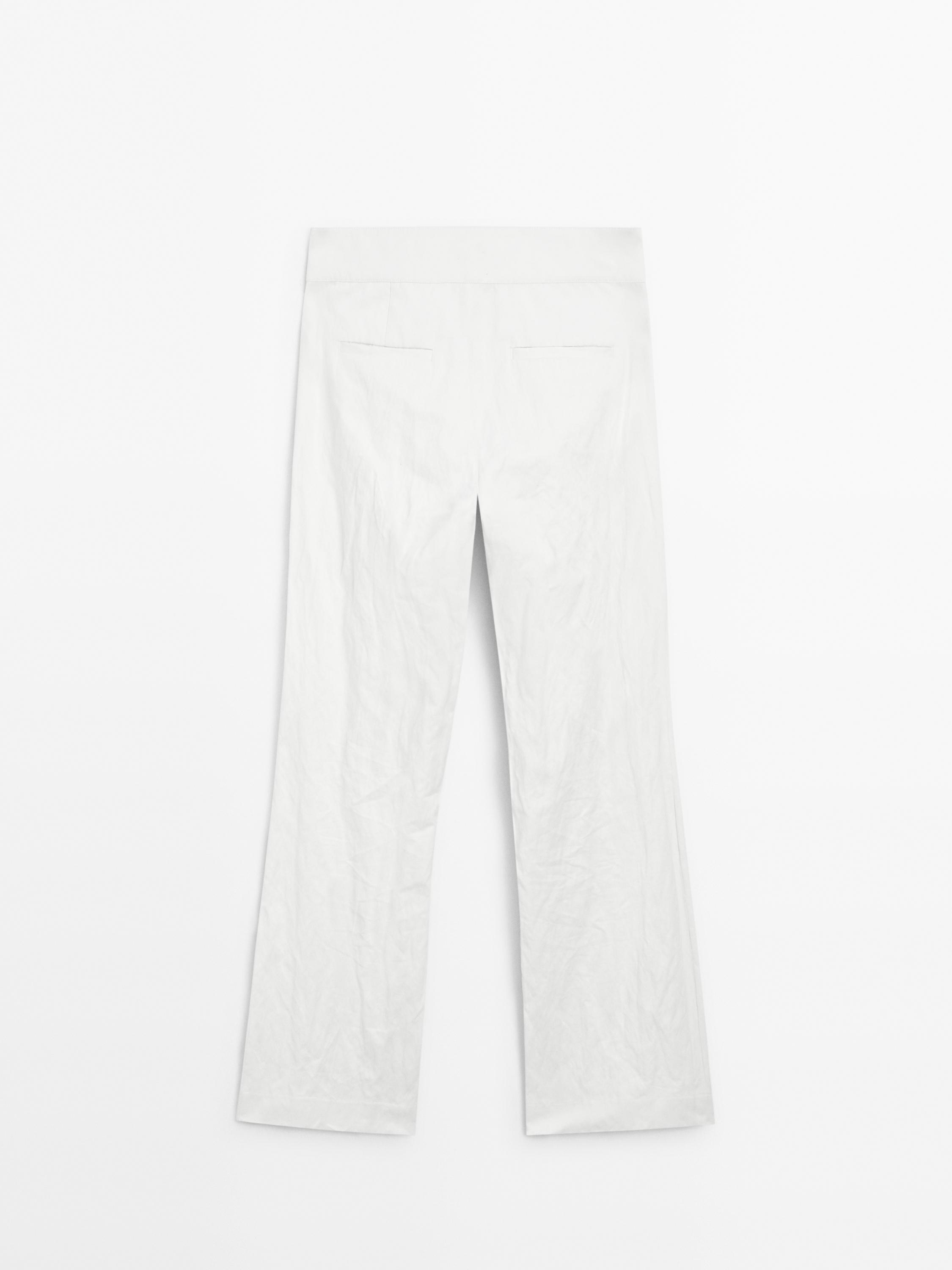 Slim fit low-rise trousers with buckles