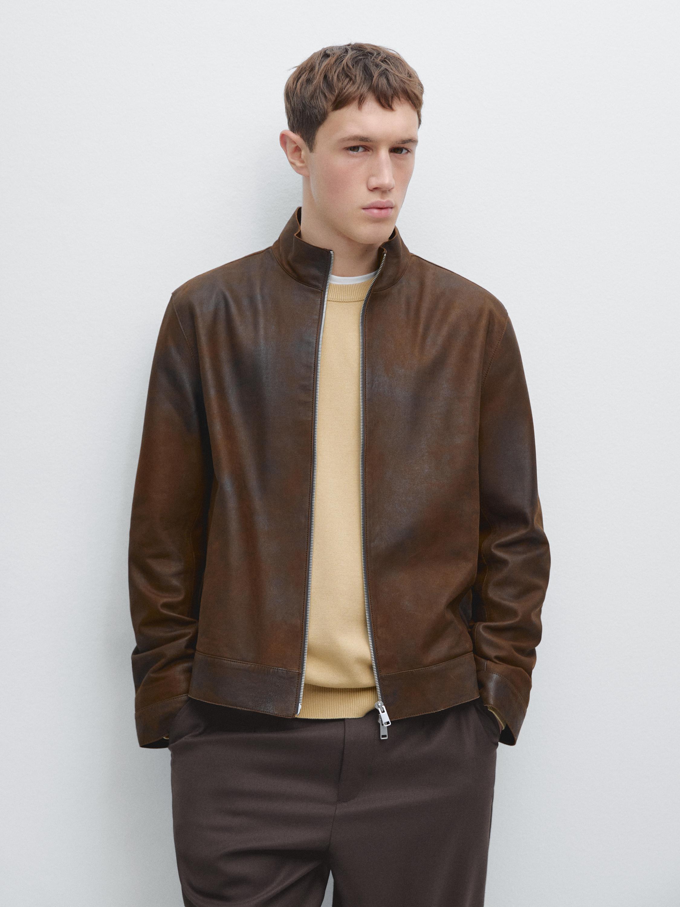 Brown jacket set with front zipper and dark pants.