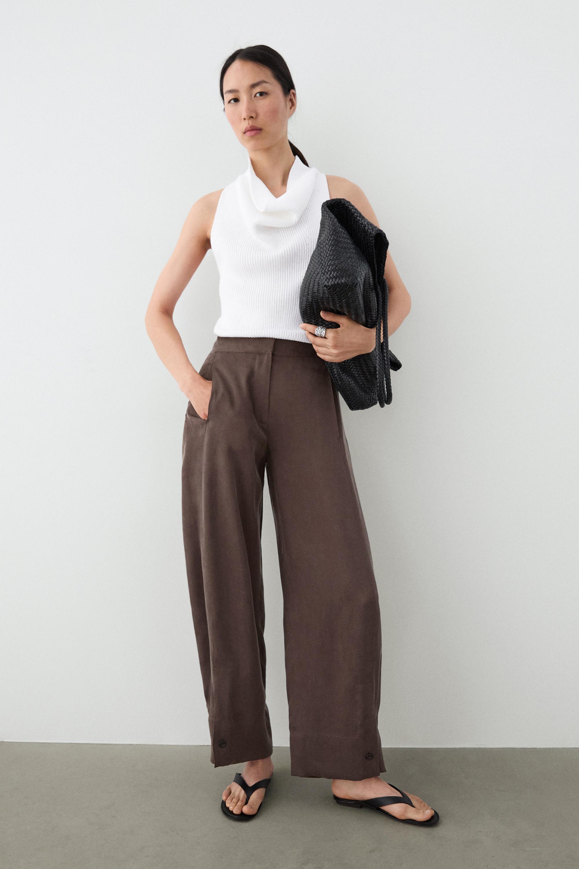 Total look flowing trousers with buttoned hems — PLUM
