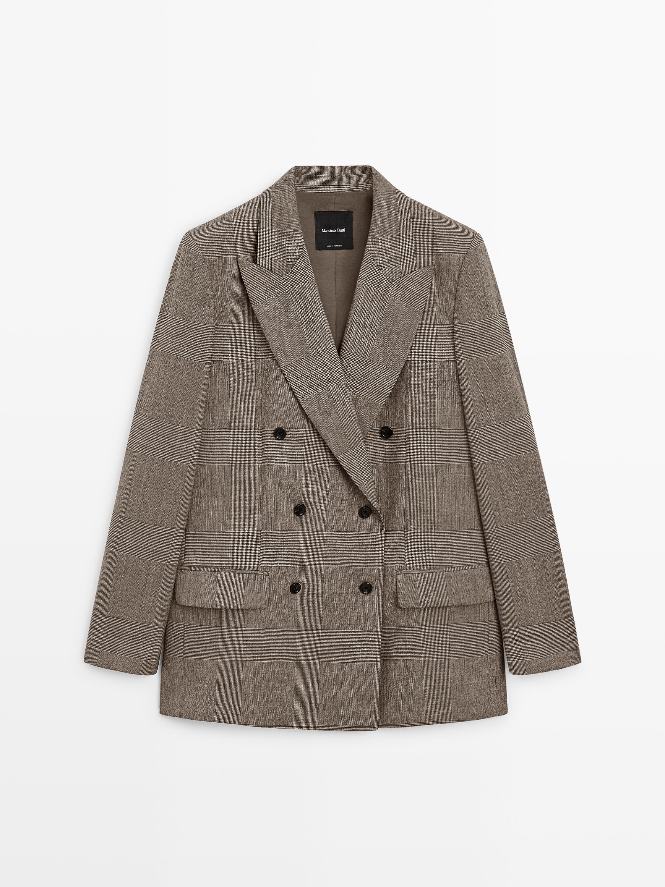 Front view of a beige double-breasted blazer with flap pockets.