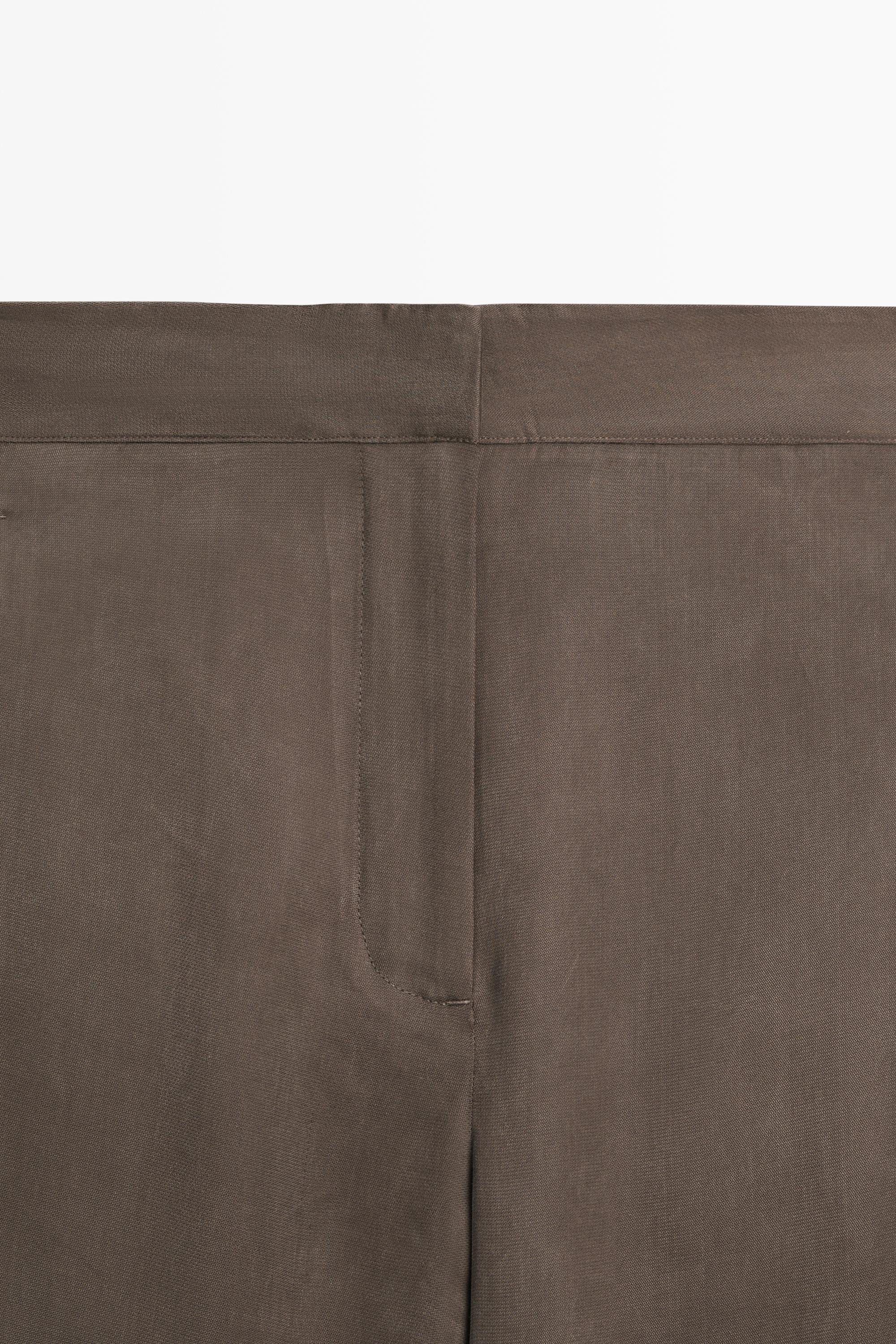 Total look flowing trousers with buttoned hems — PLUM