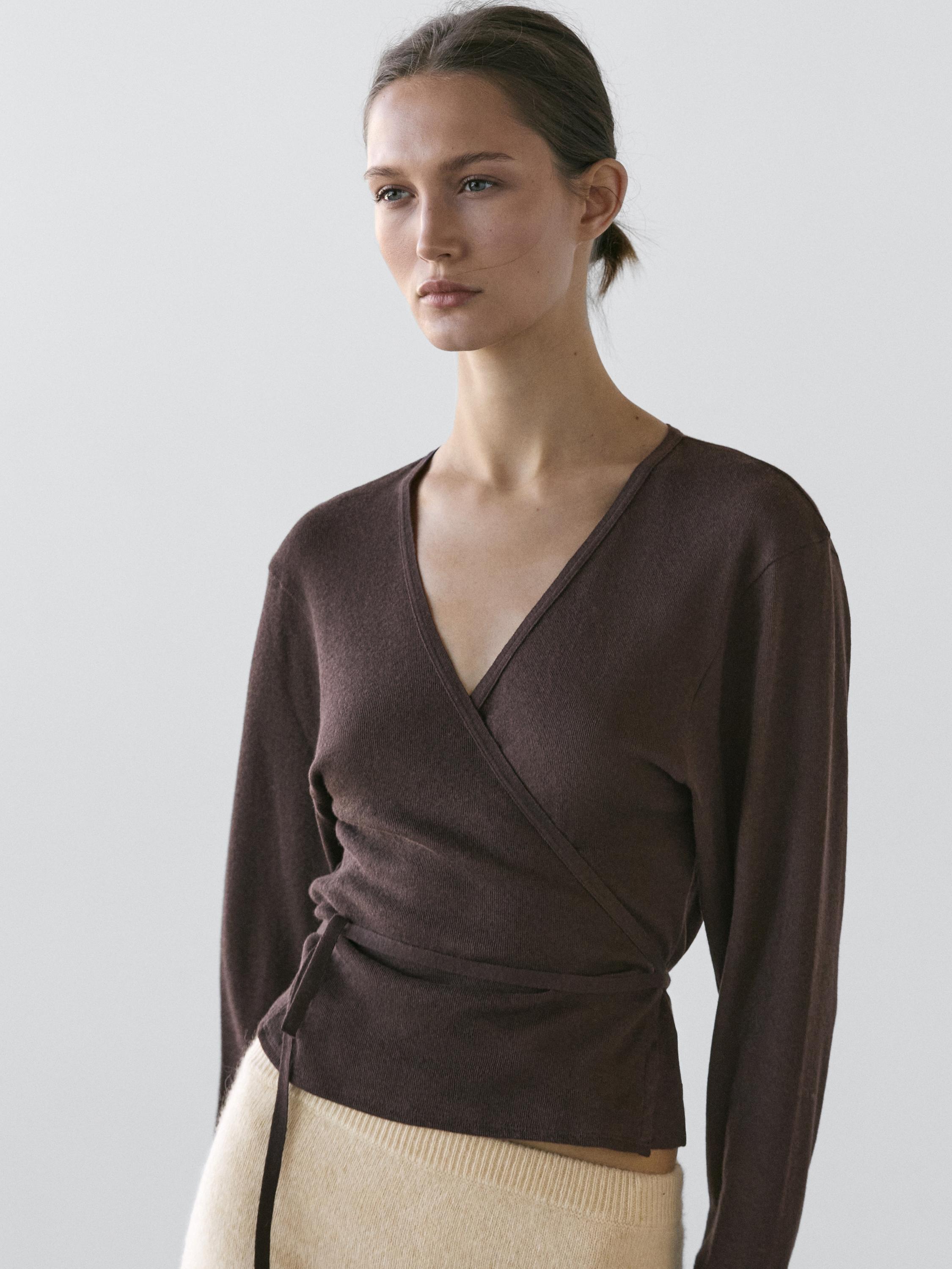 Medium shot of a long-sleeved brown cardigan with a wrap design and a tie at the waist.