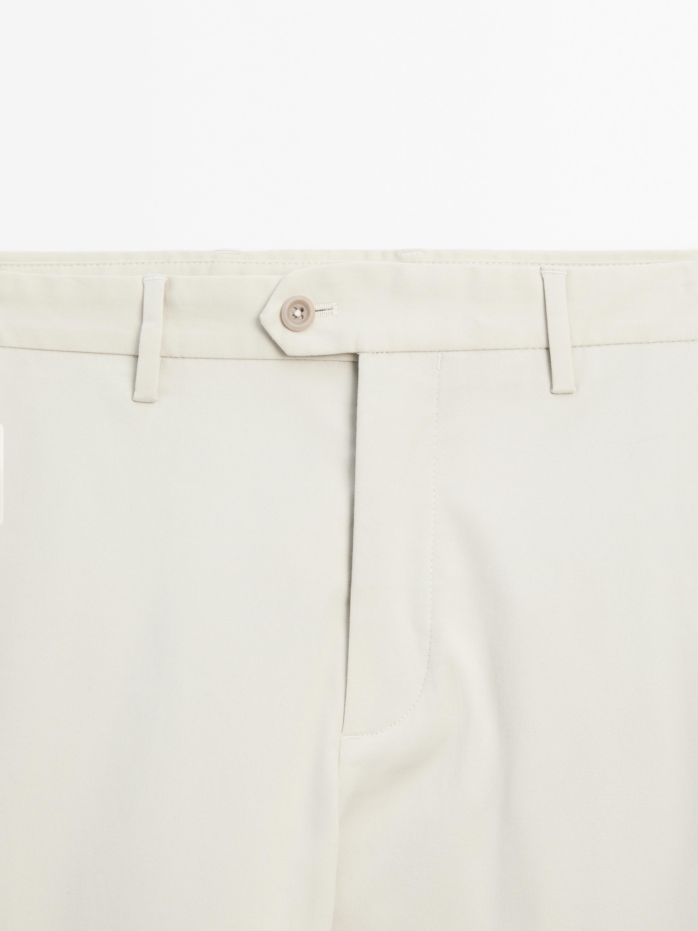 Tapered fit trousers with buckle detail