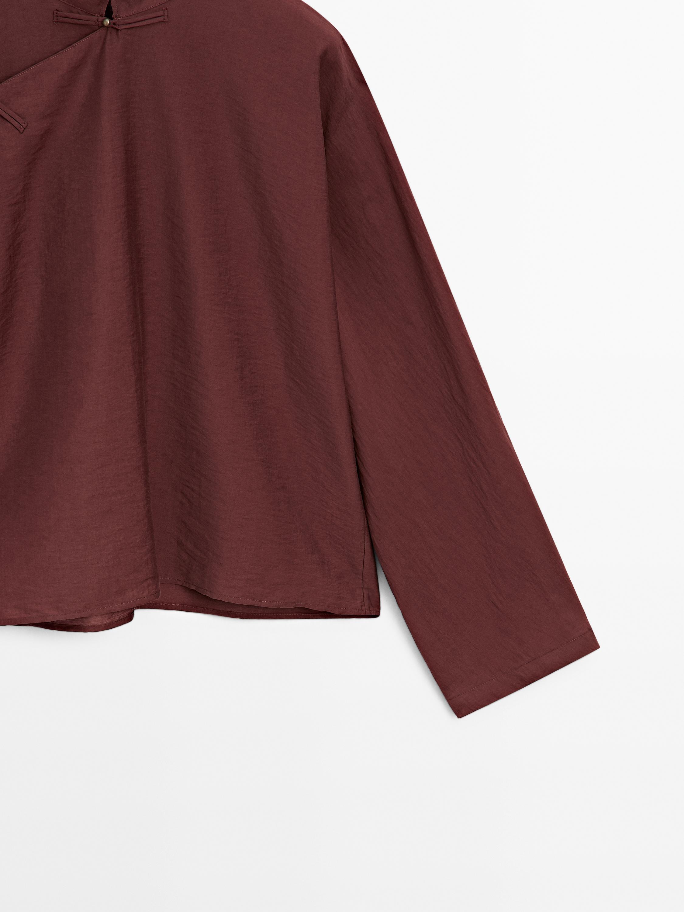 Flowing blouse with fastening detail