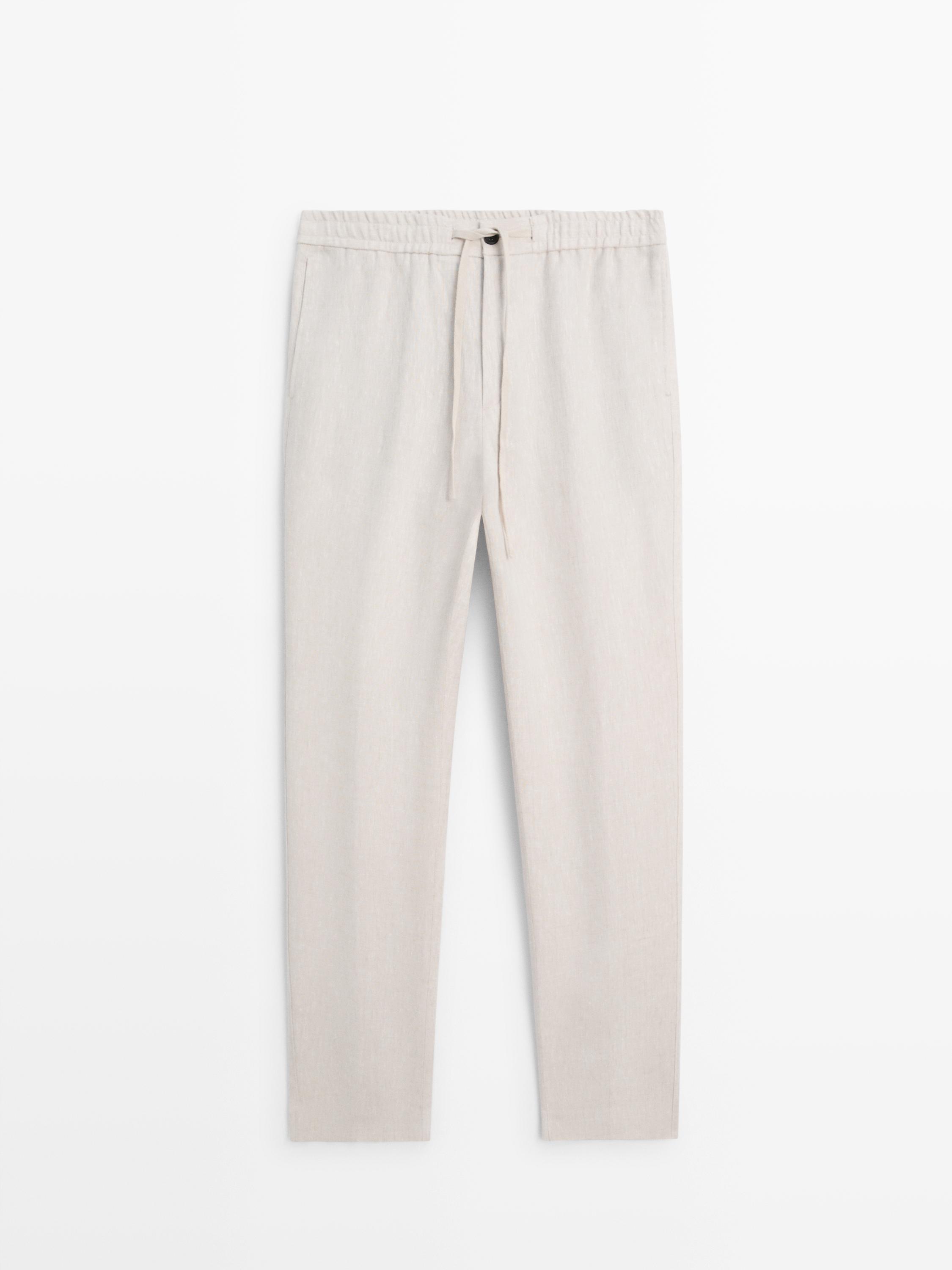 Front view of sand-colored jogger pants with an elastic waistband and adjustable drawstring.