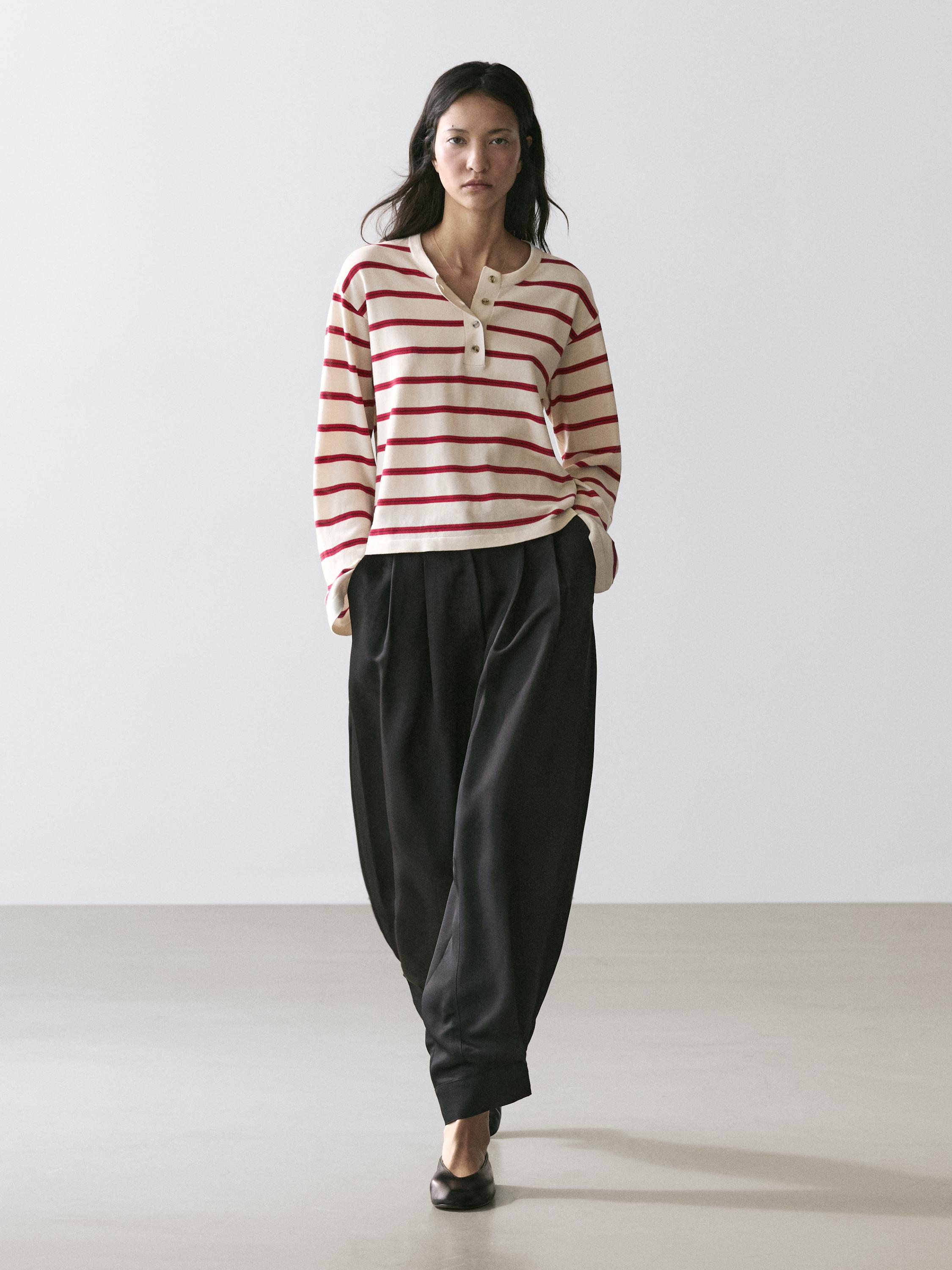 Red striped jersey set with a baker collar and wide black pants.