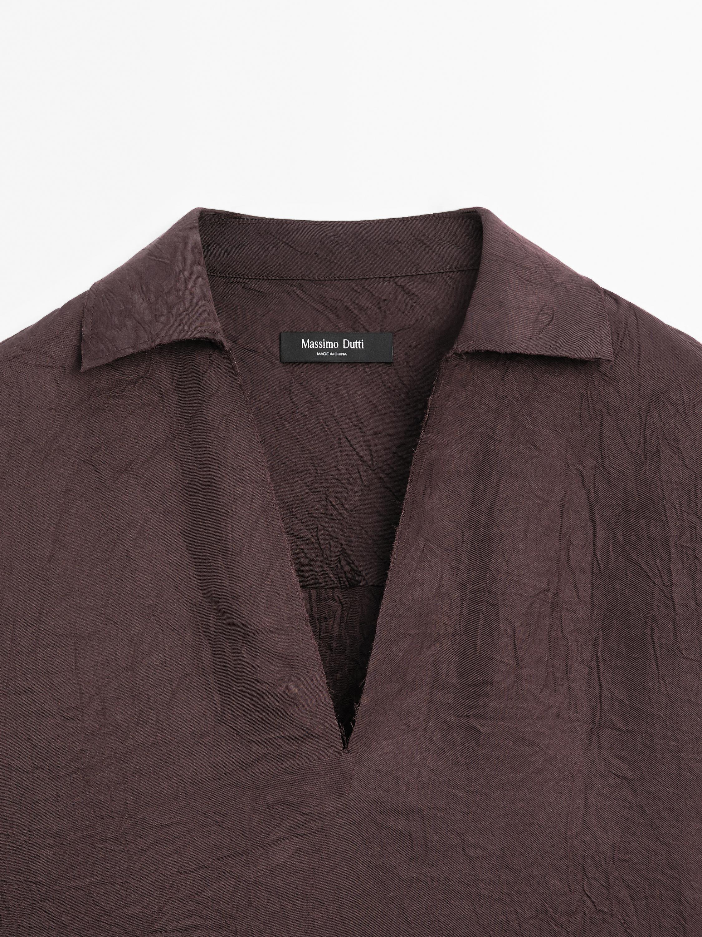 Flowing shirt featuring long sleeves with vents