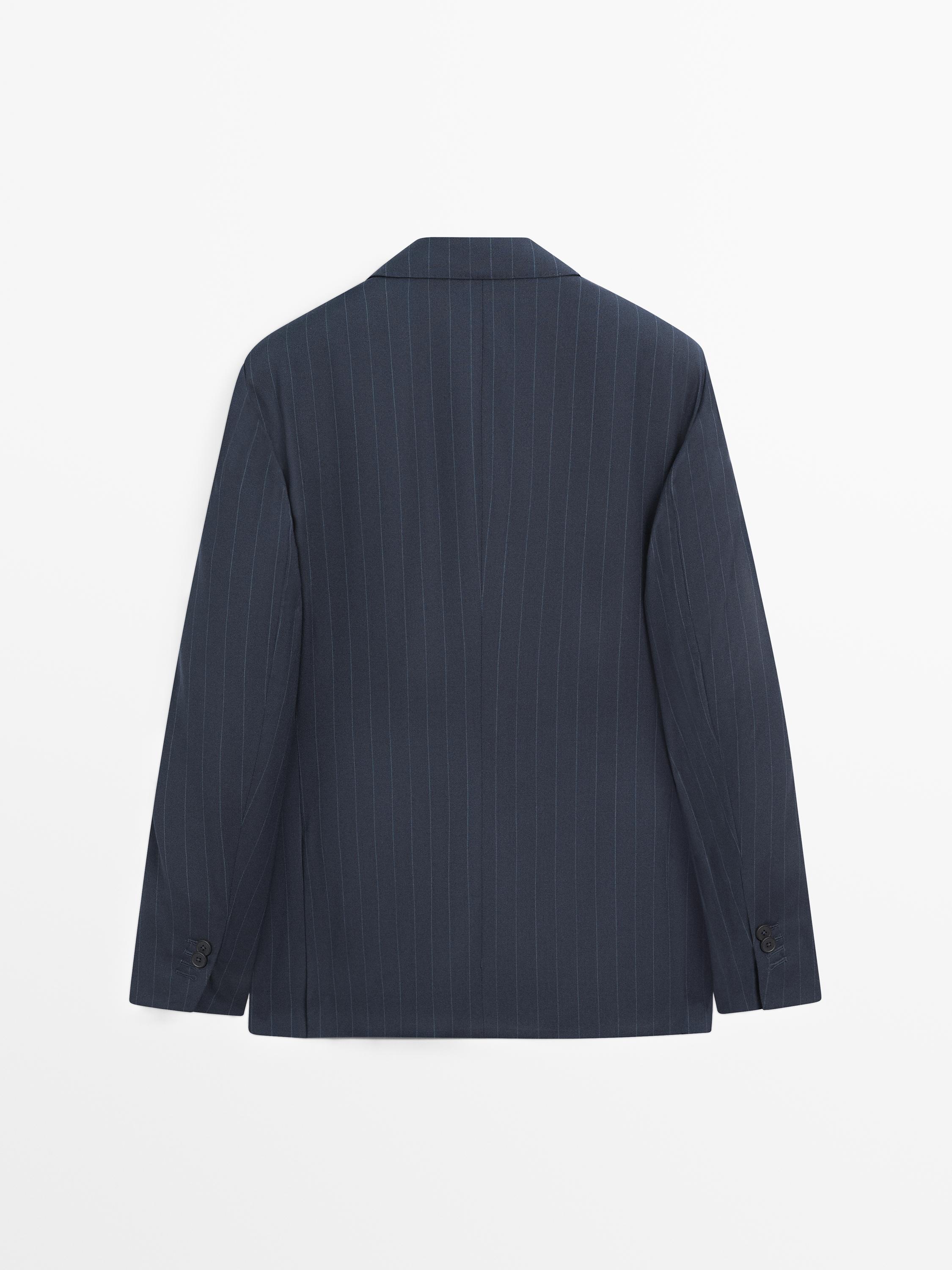 Rear view of a navy blue blazer with thin stripes and buttons on the sleeves.