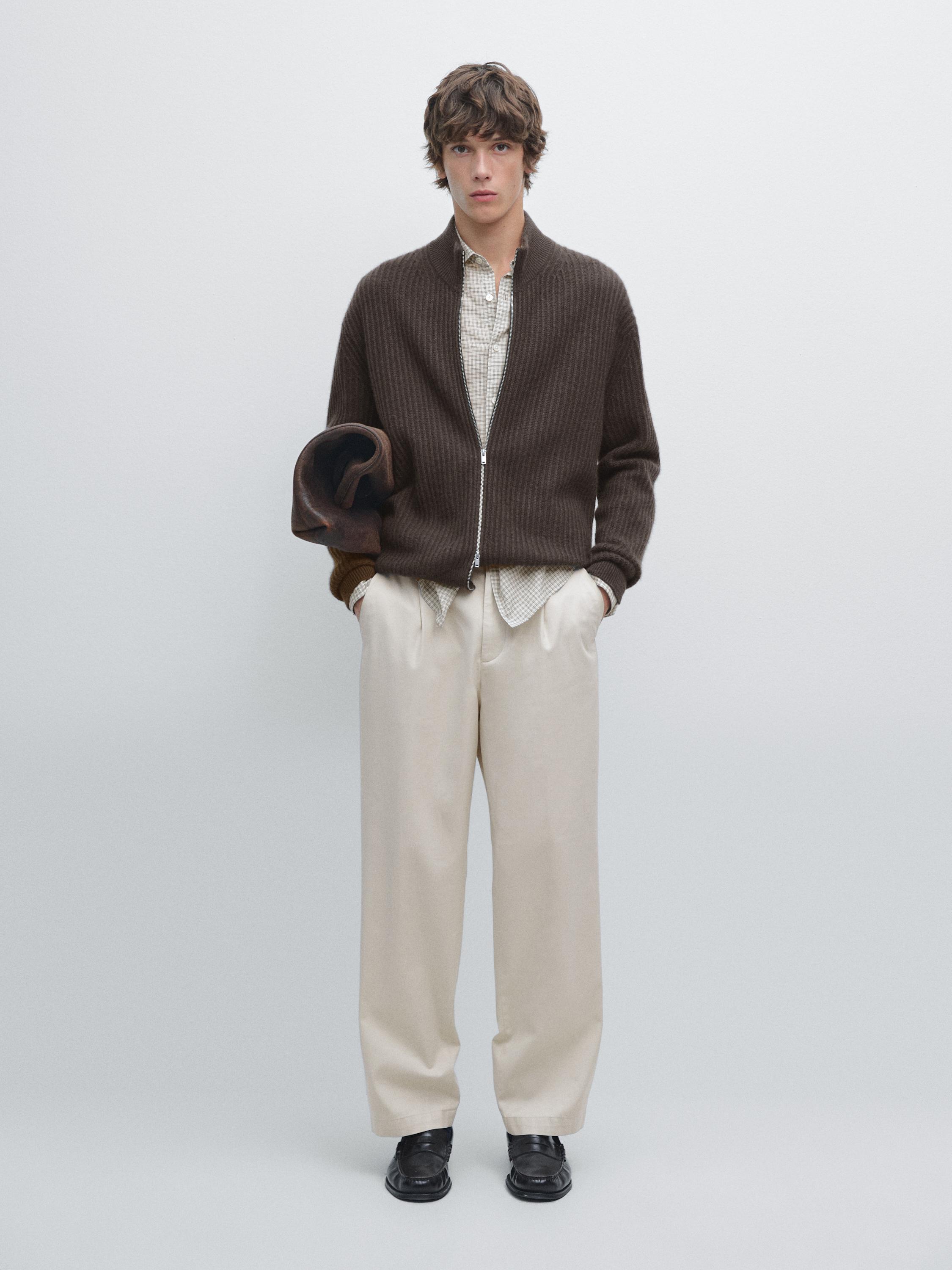 Marl brown zip-up cardigan set, beige plaid shirt, and straight-cut beige pants.