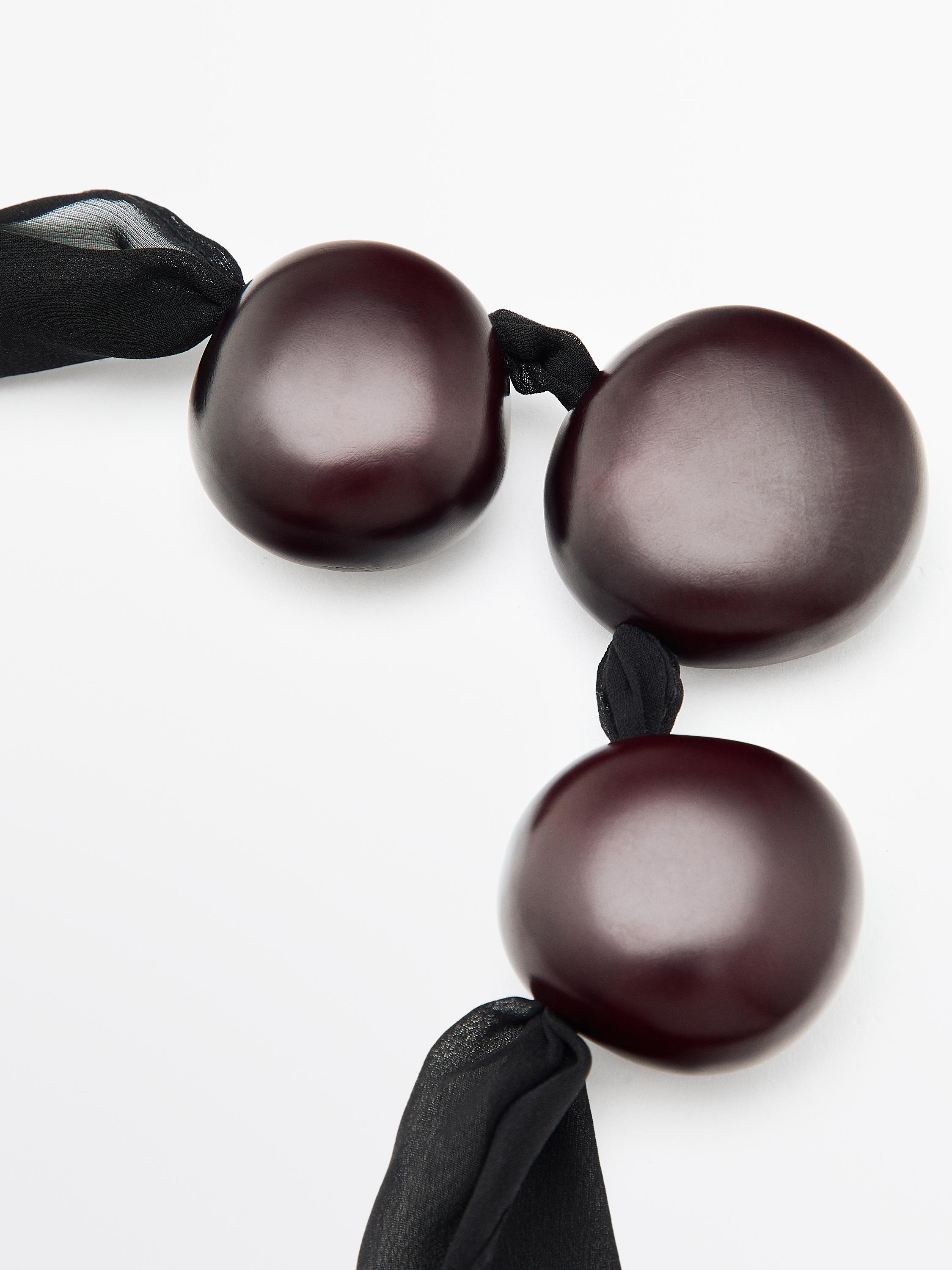 Fabric pendant with wooden beads