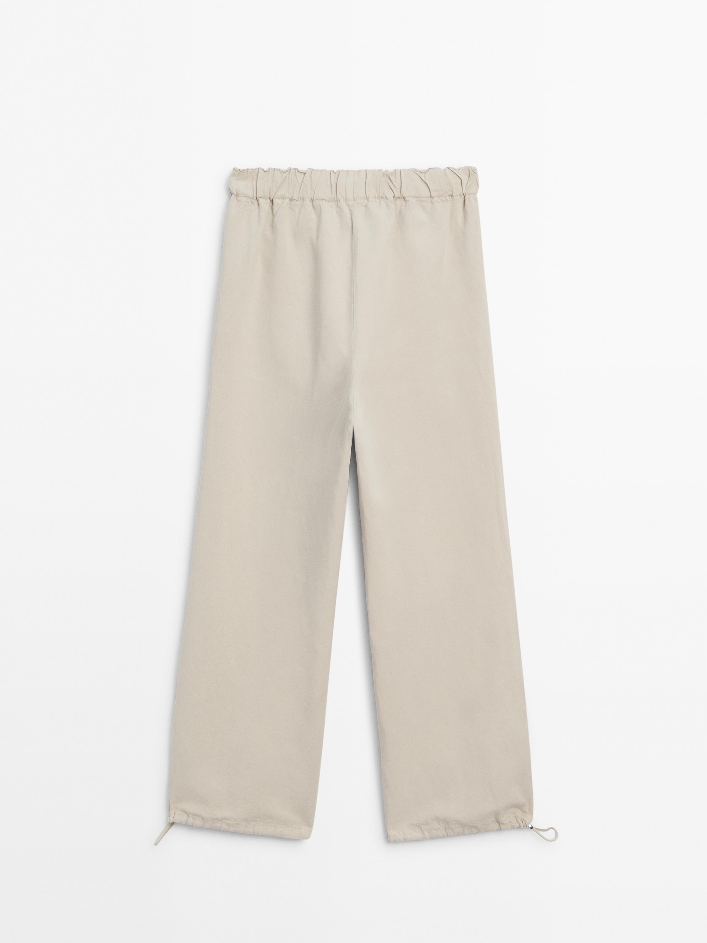 Trousers with elasticated waistband and adjustable hems