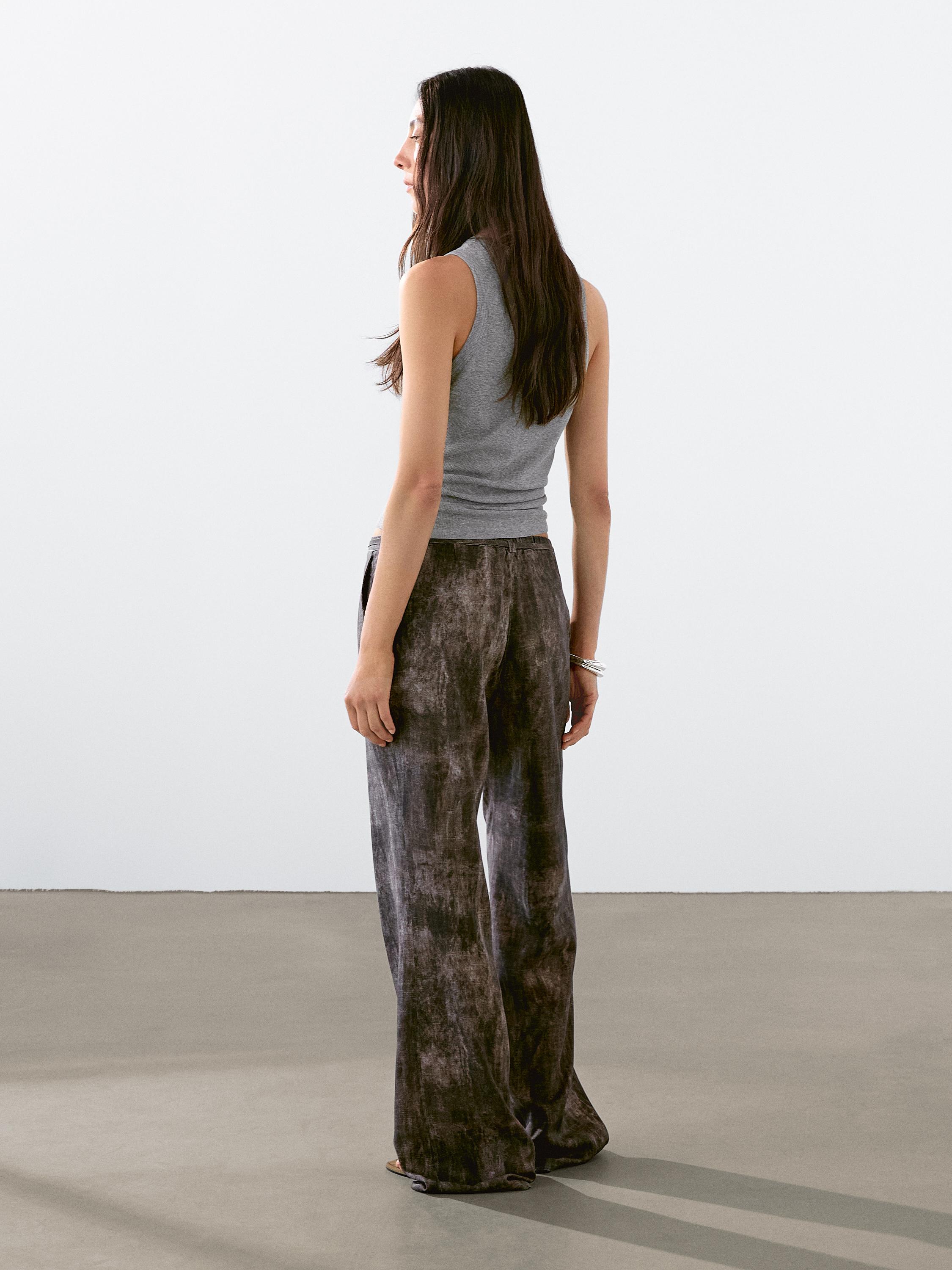 Distressed-effect flared trousers