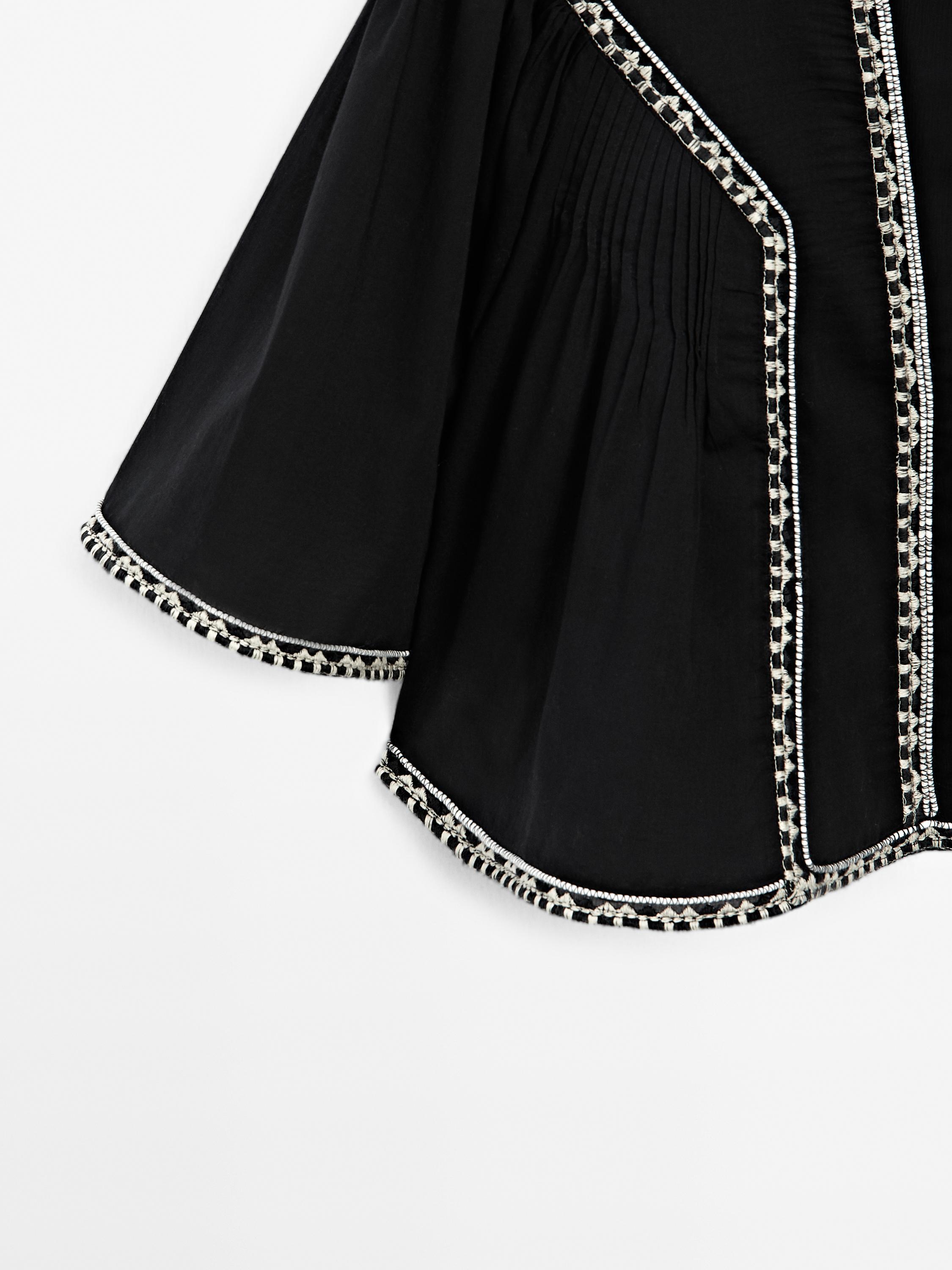 Flowing blouse with embroidered details