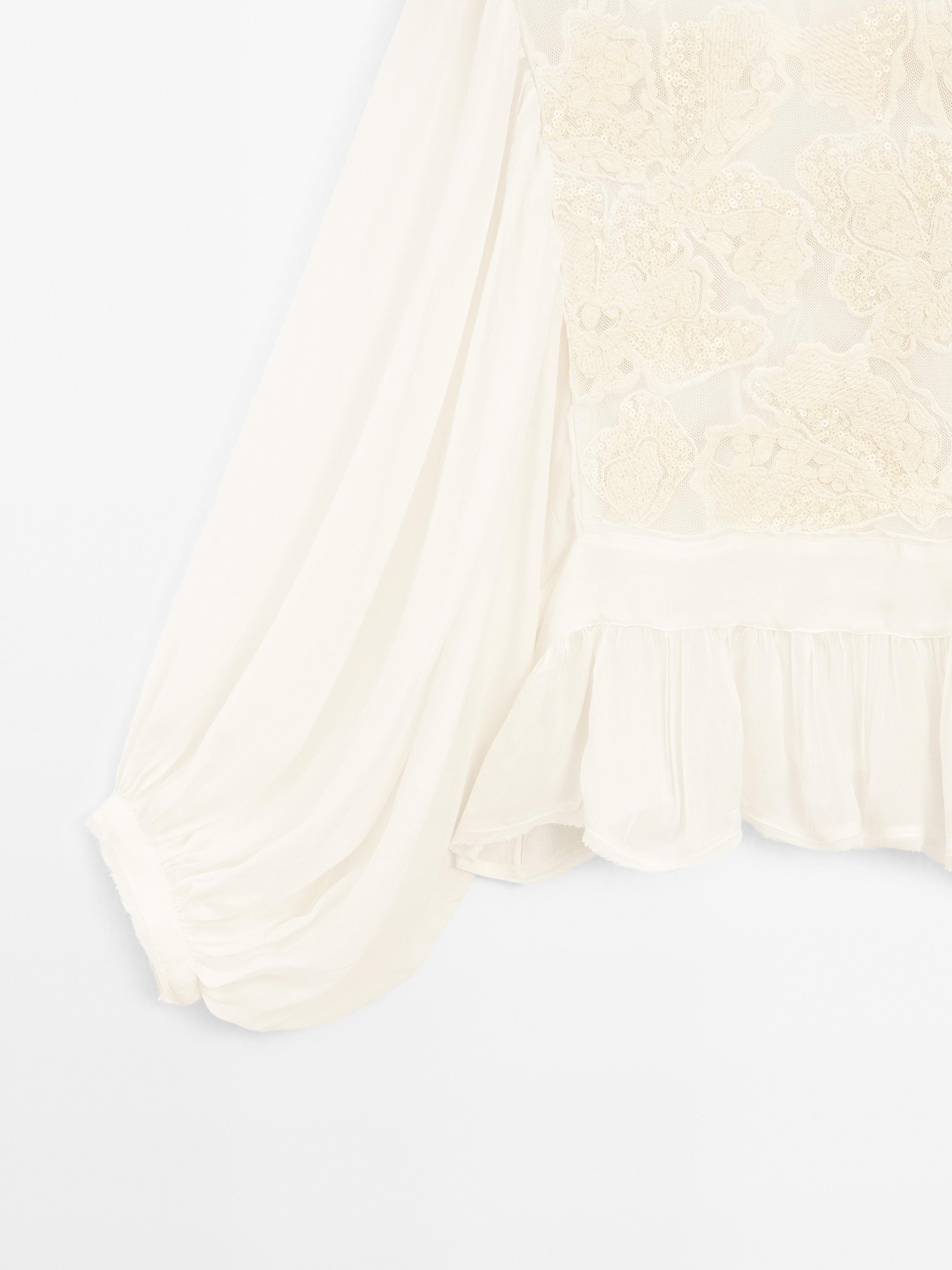 Flowing embroidered peplum blouse