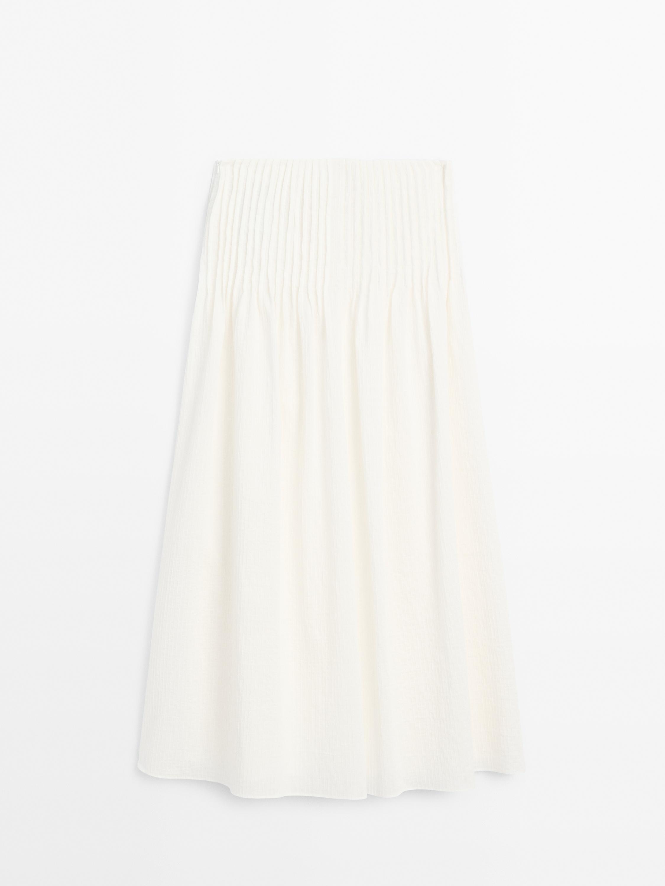Long pleated skirt with fabric detail