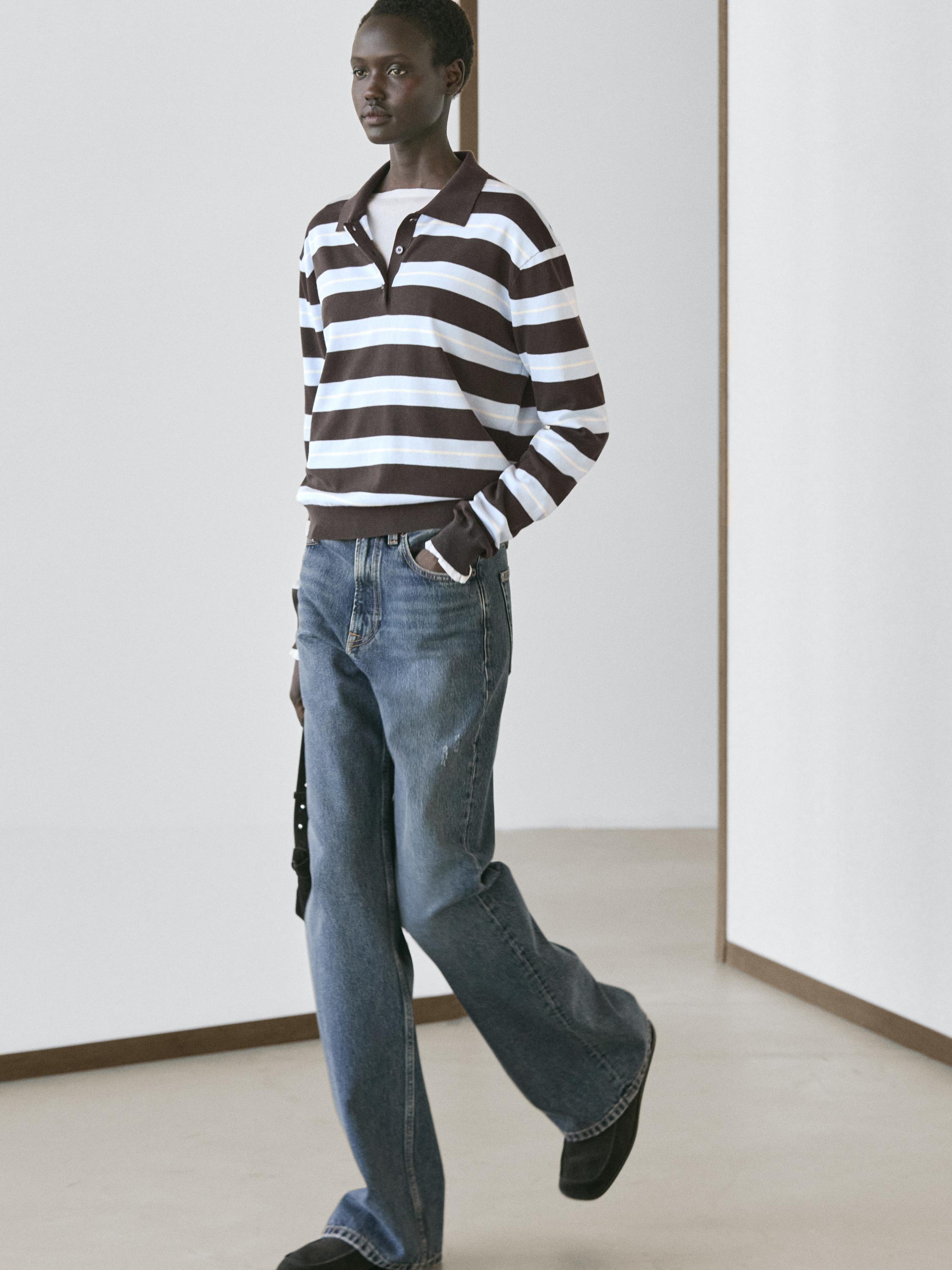 Brown striped polo neck sweater and straight-cut blue jeans set.