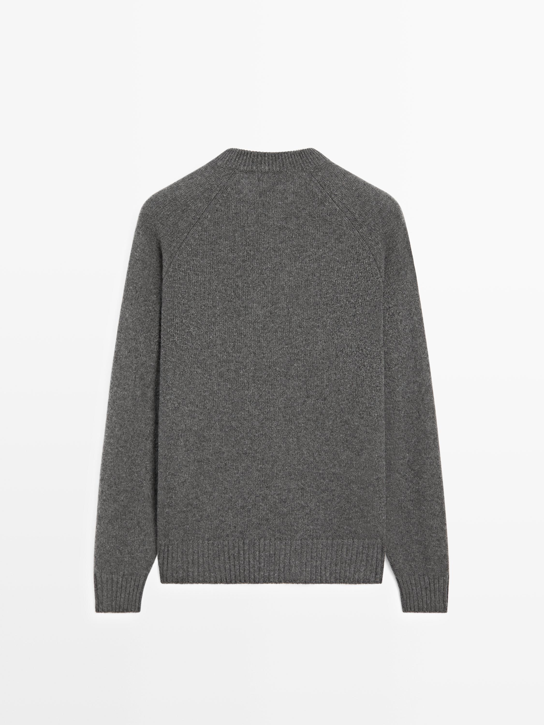 Back view of a medium gray knitted crewneck long-sleeve sweater.