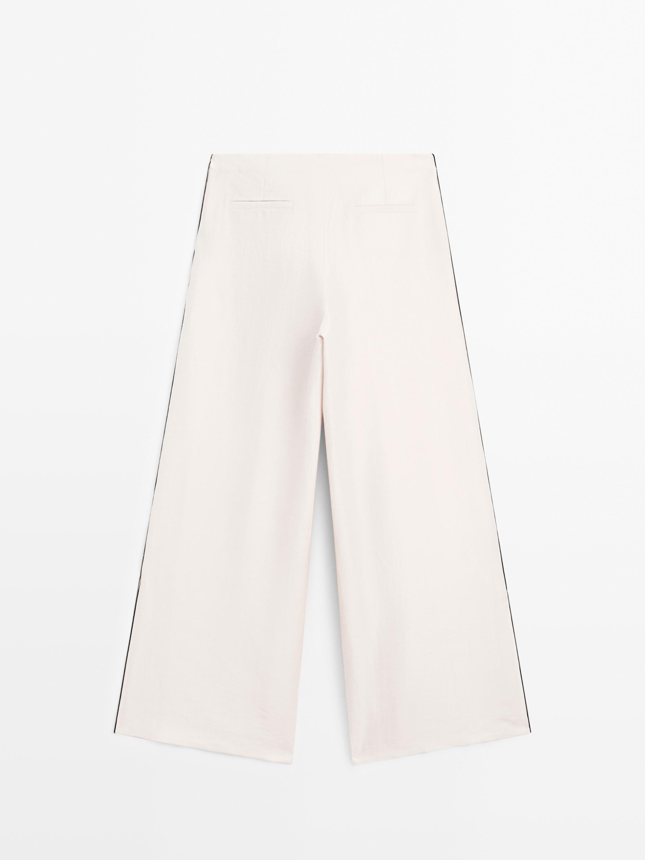 Flowing trousers with contrast trims