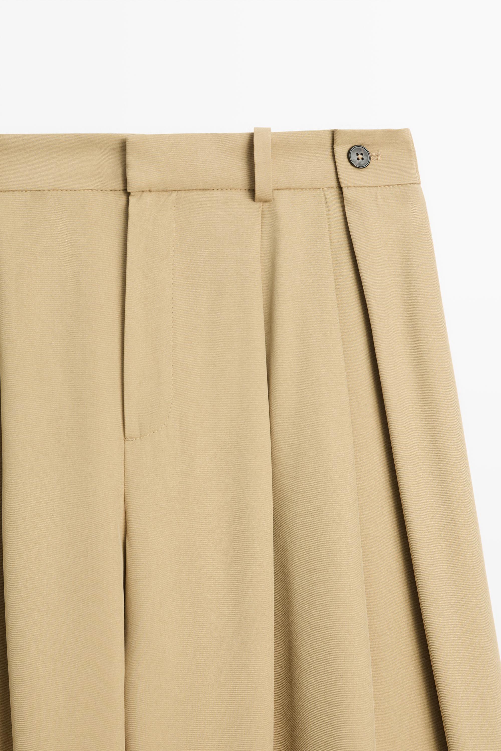 Flowing pleated pants with button detail — BEIGE