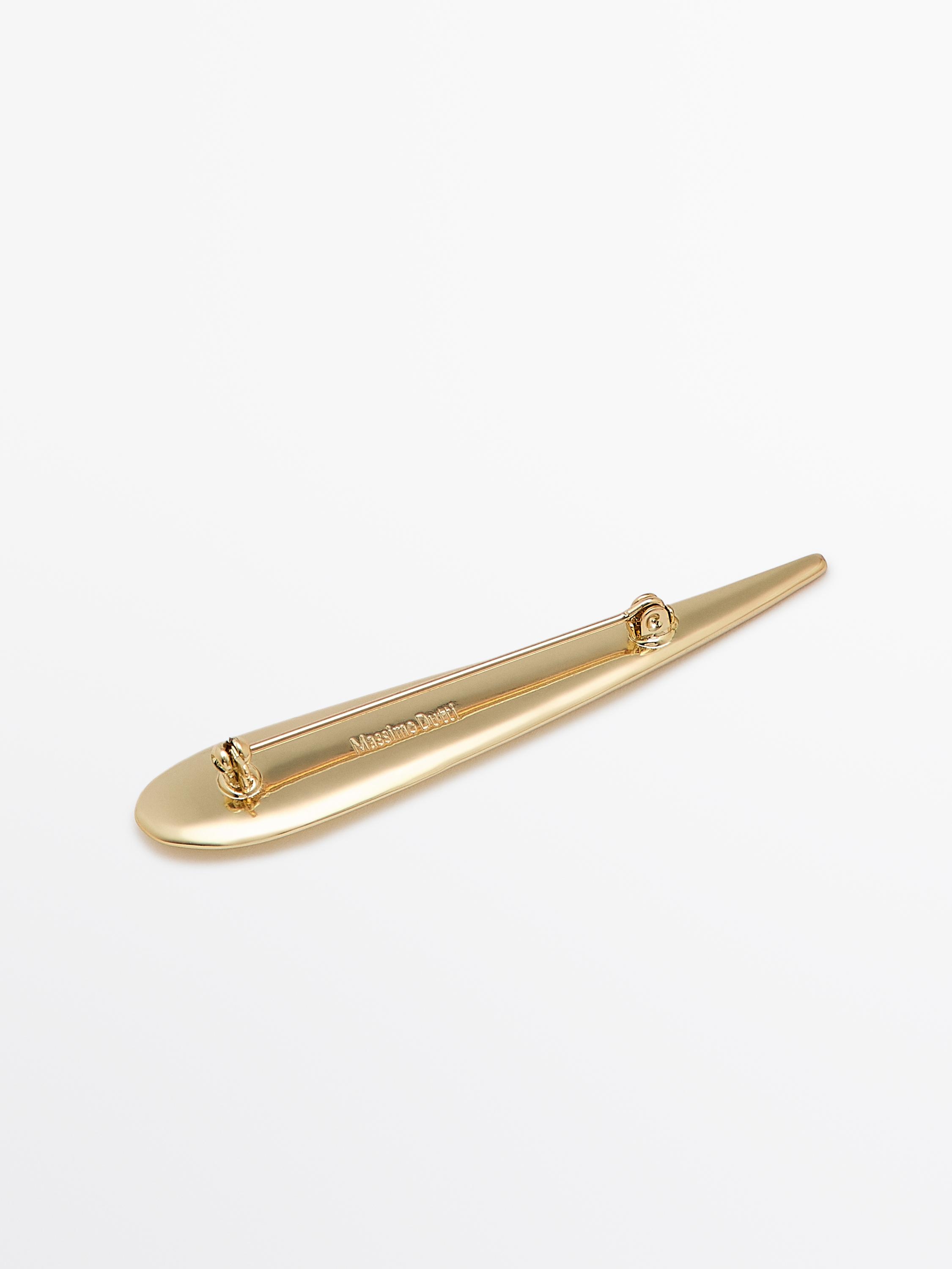Golden teardrop brooch
