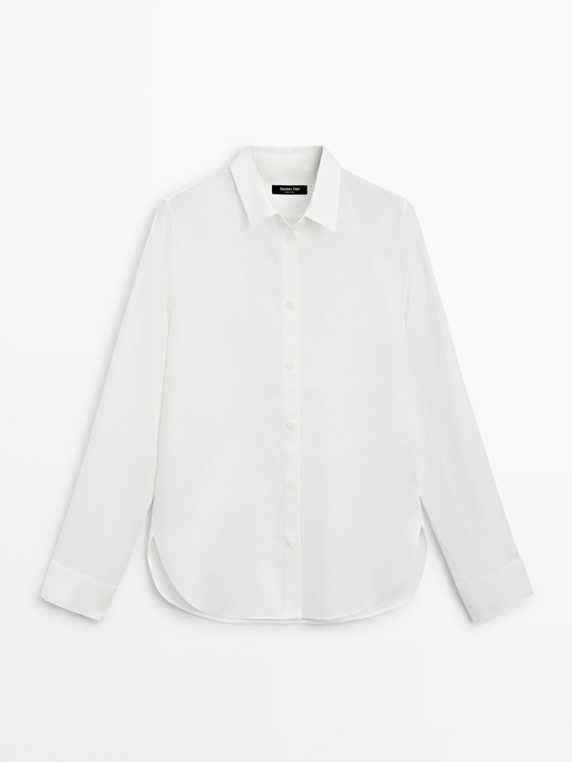 Front view of a flowing white shirt with a classic collar, central button placket, and long sleeves.